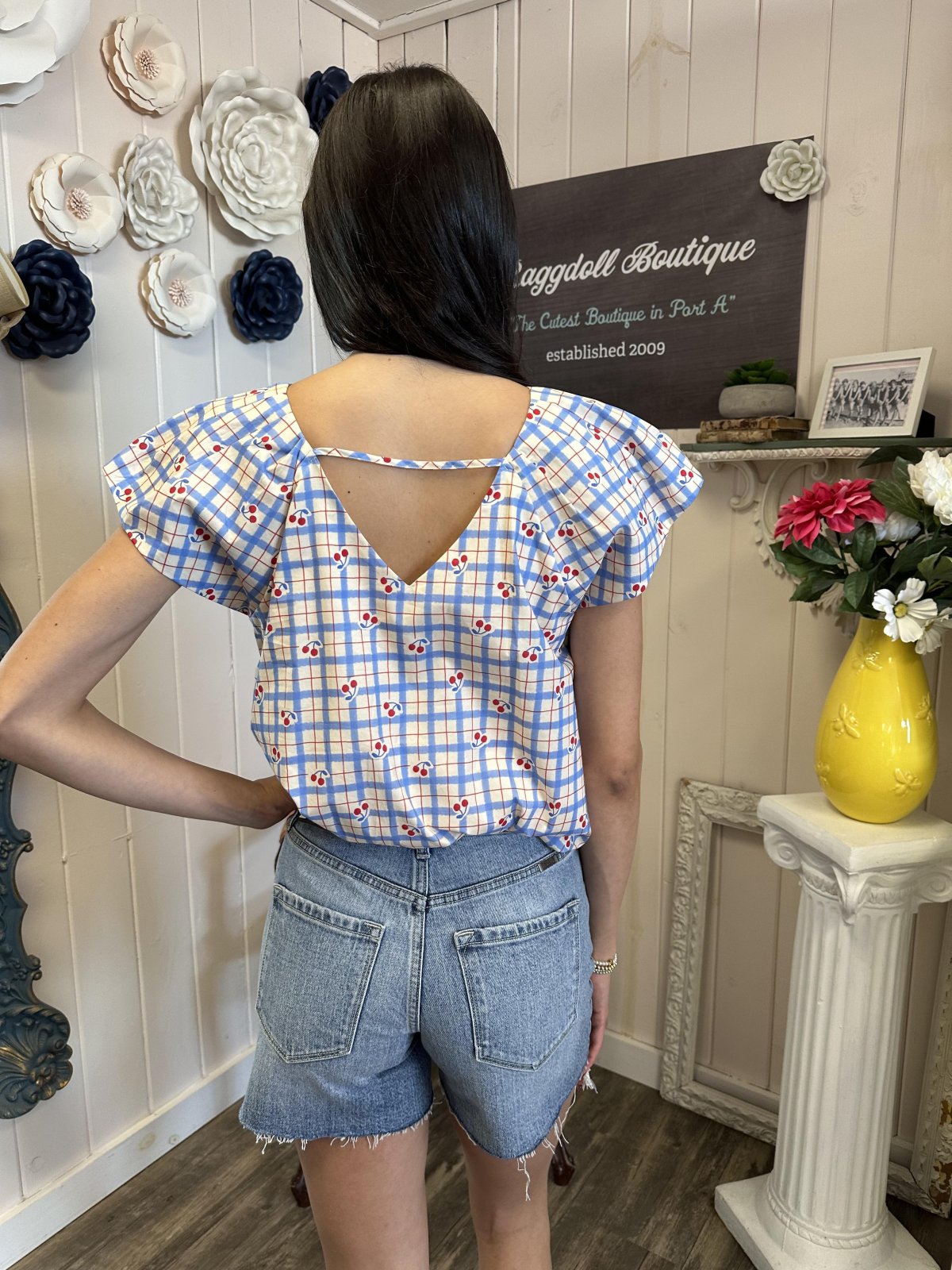 Stylish cherry print blouse with checker pattern, perfect for coastal boutique clothing and casual outings.