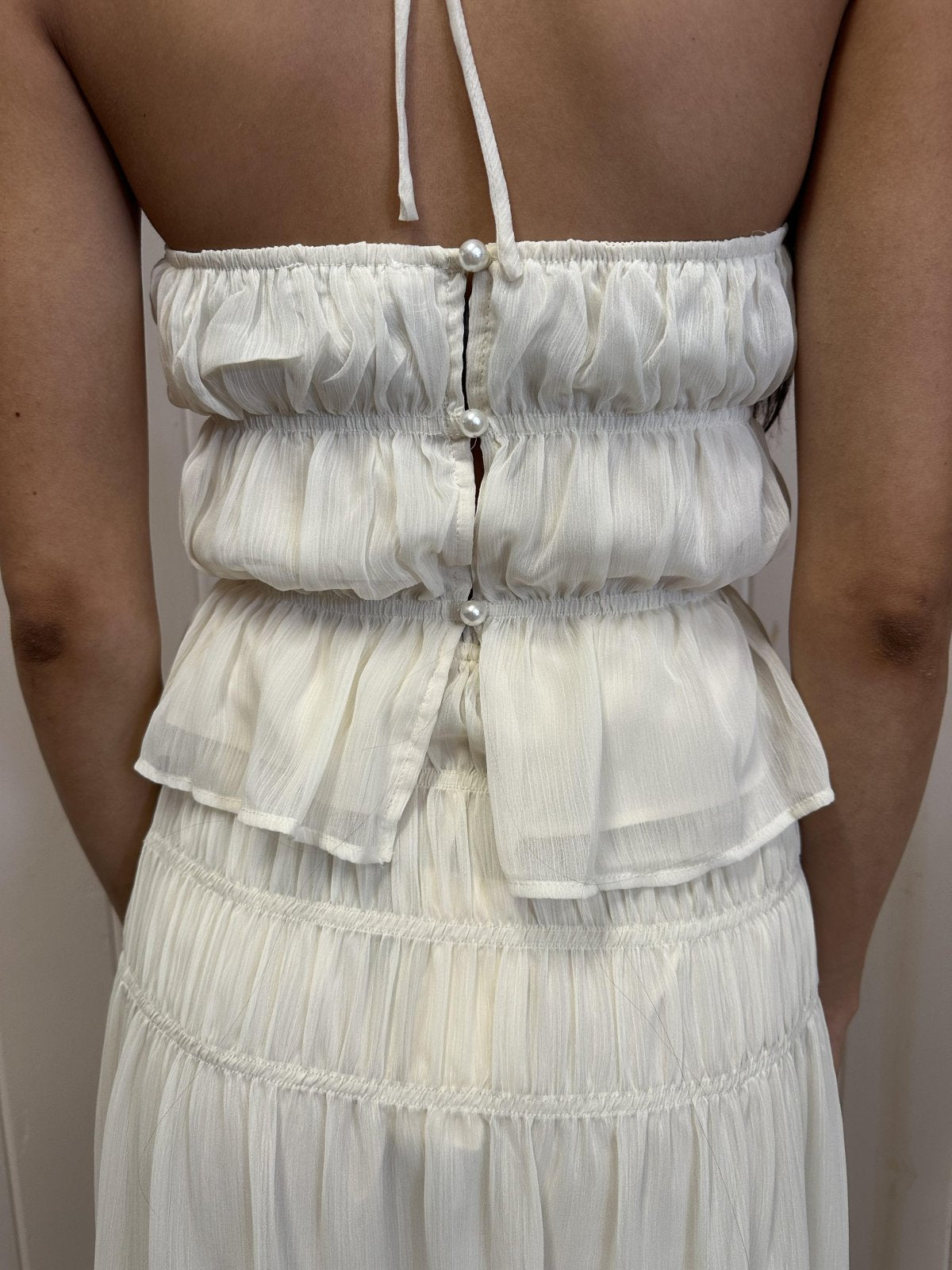 Back view of white chiffon top with smocked waistband, perfect for beach dresses and curated women's fashion at coastal boutique.
