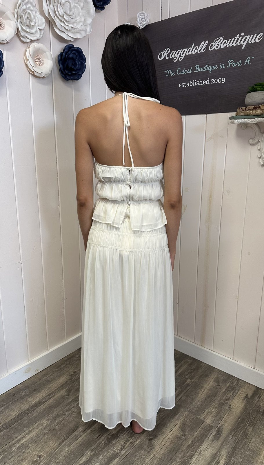 Back view of a model in the White Chiffon Top & Maxi Skirt Set from a Port Aransas boutique, perfect for beach dresses.