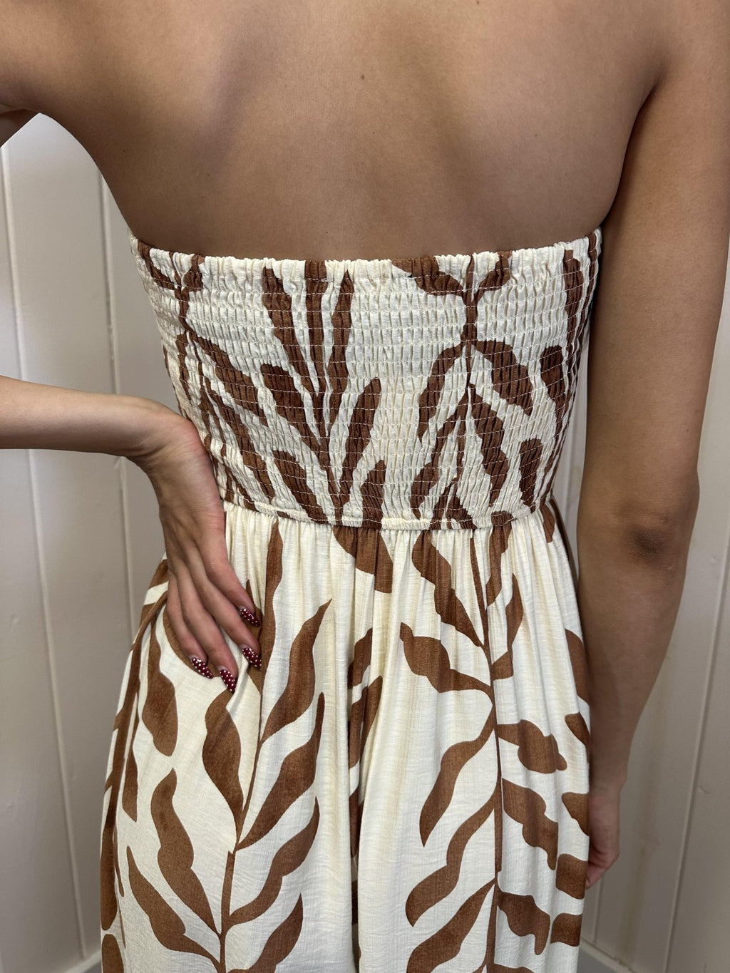 Back view of ivory and light brown tube top jumpsuit with smocked elastic detail, perfect for coastal boutique clothing.