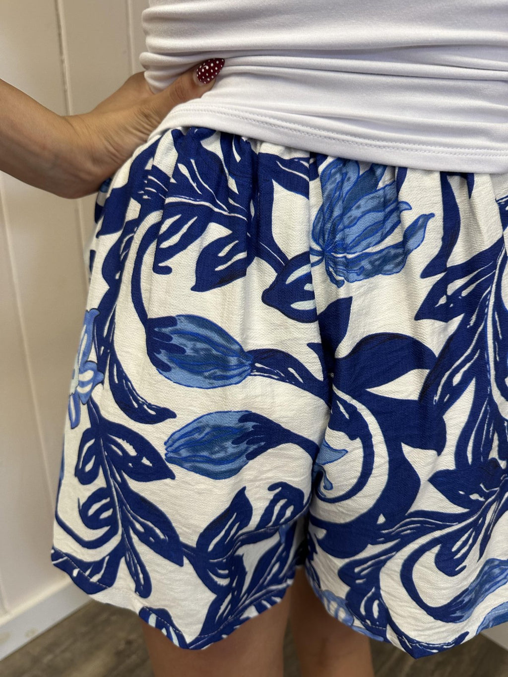 Mia Shorts with blue floral print, perfect women's bottoms from a coastal boutique, ideal for casual summer wear.