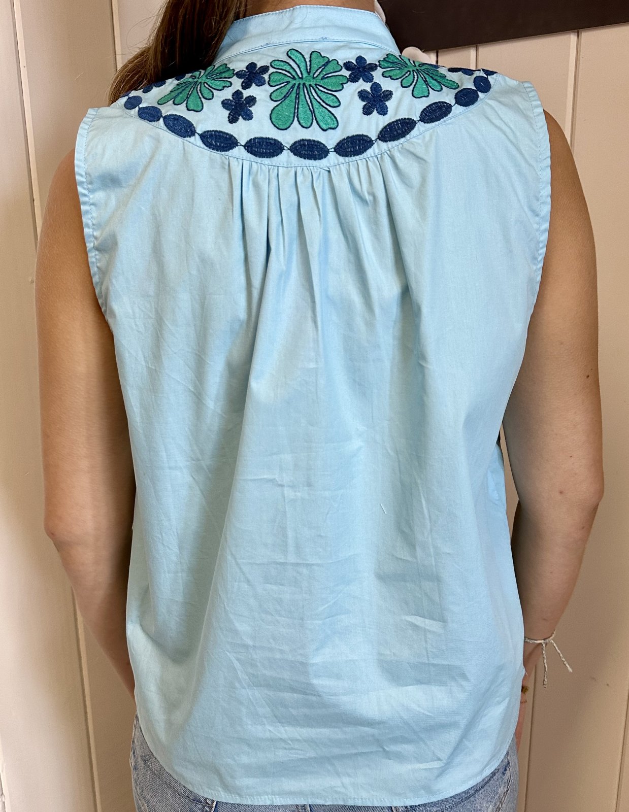 Back view of the vibrant Molly Top with detailed embroidery, perfect for coastal boutique clothing and stylish tops for women.