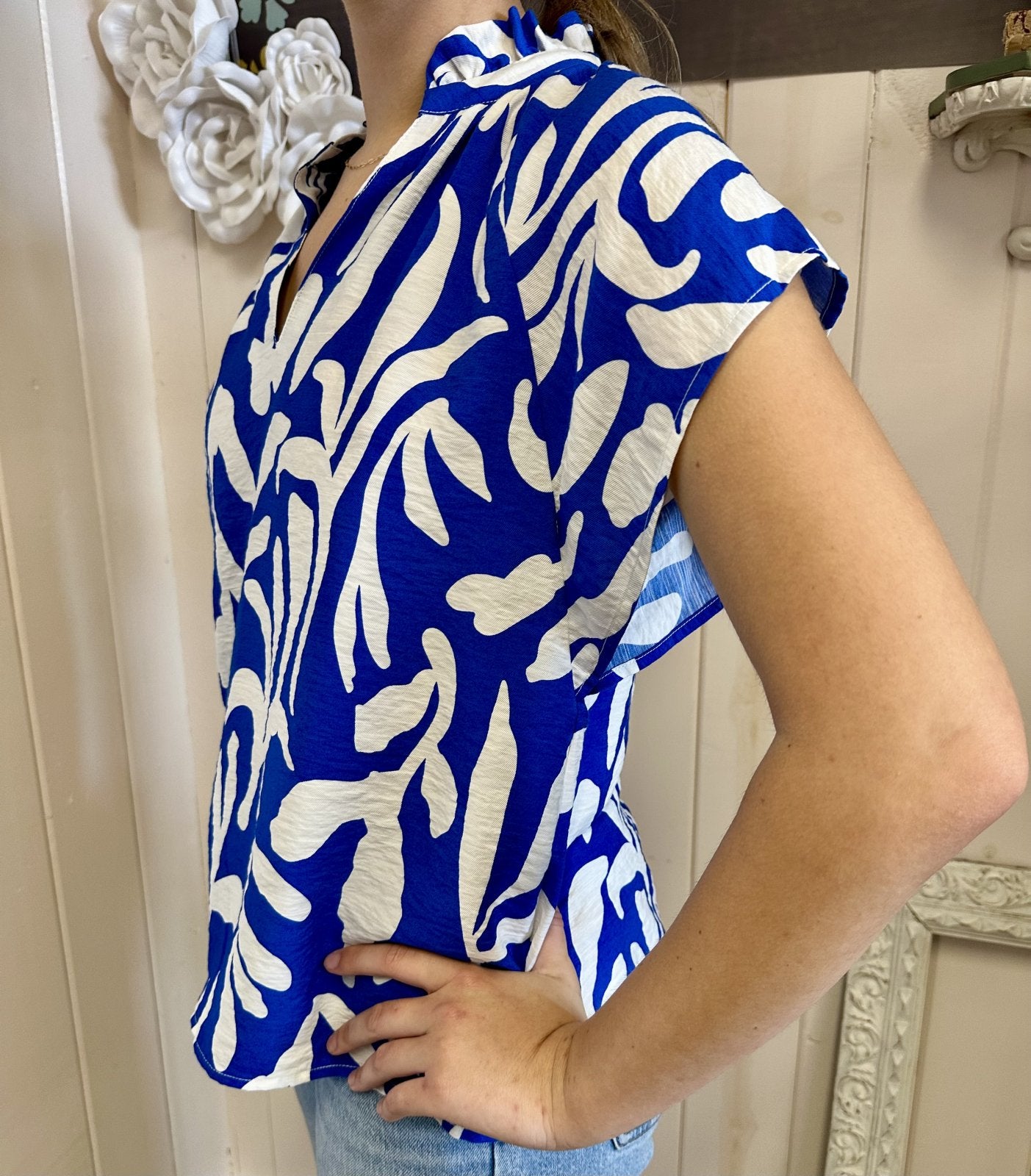 Stylish blue and white top with ruffle collar, perfect for coastal boutique clothing and tropical vacation dresses.