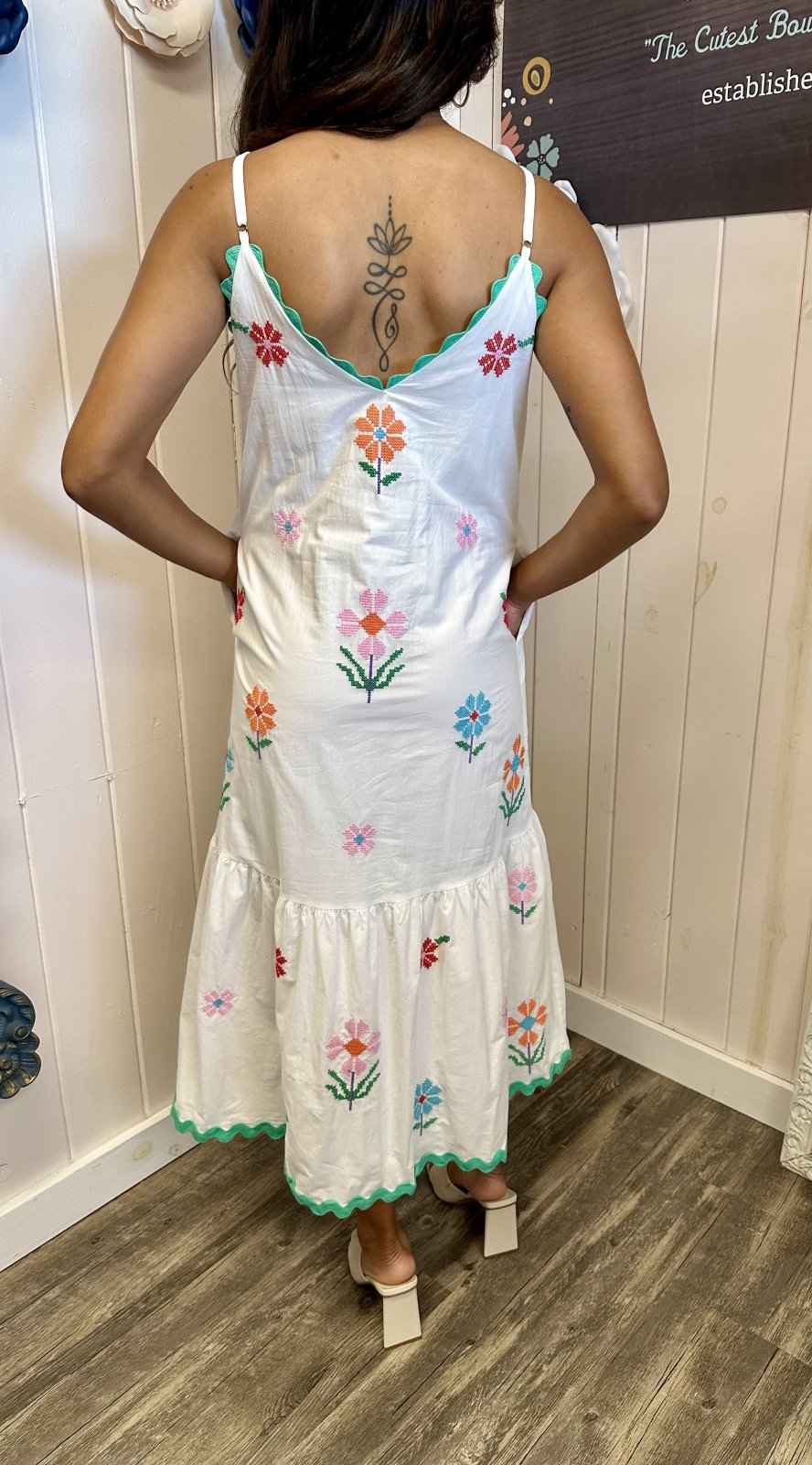 Back view of Teagan Dress with floral embroidery, perfect for coastal boutique clothing and tropical vacation dresses.