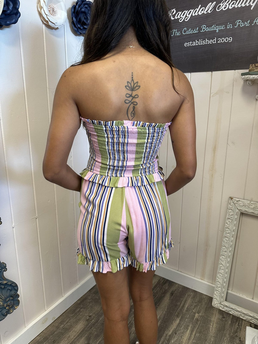 Back view of the Lori Romper, a colorful striped playsuit perfect for summer at a Port Aransas boutique.