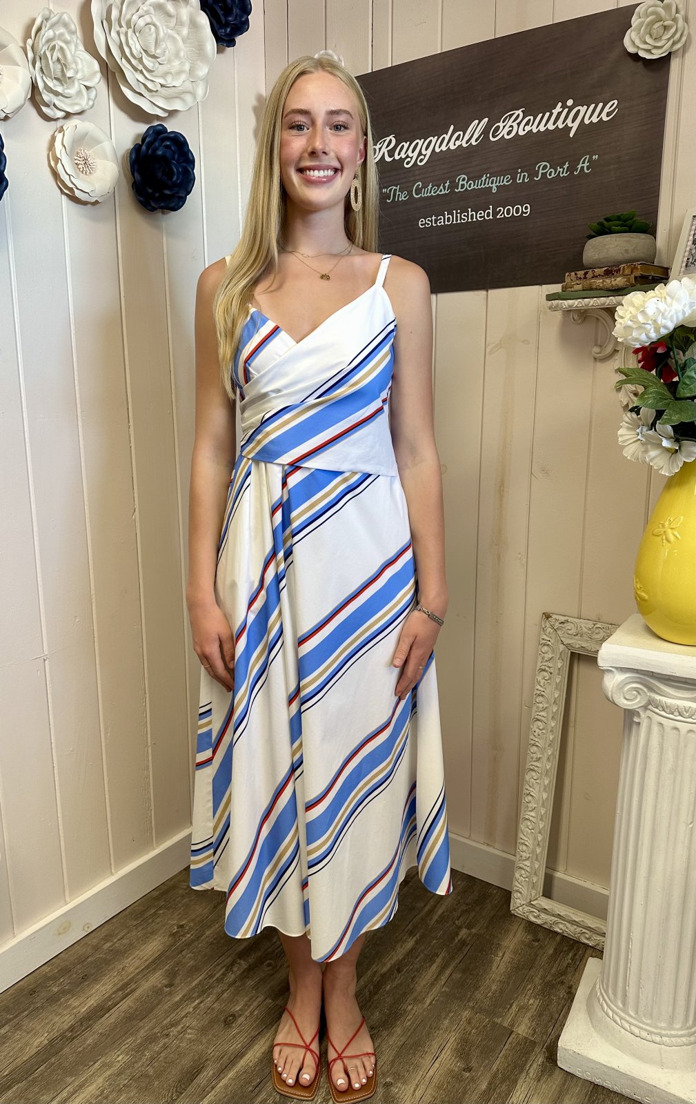 Charming blue and red multi-stripe Fisher Dress perfect for summer, featured in a coastal boutique clothing collection.