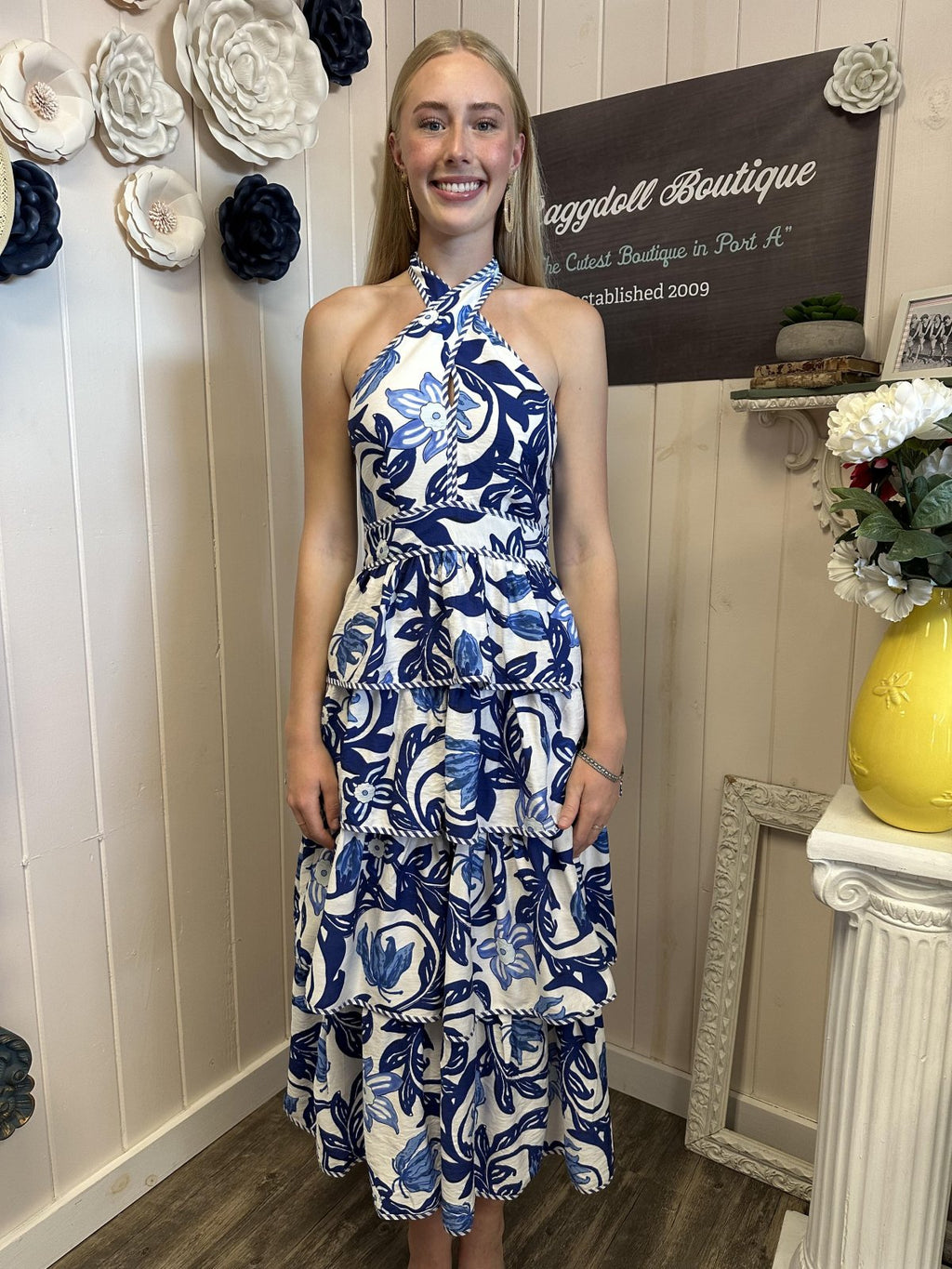 Model in a tiered blue paisley print midi dress from a Port Aransas boutique, perfect for summer beach occasions.