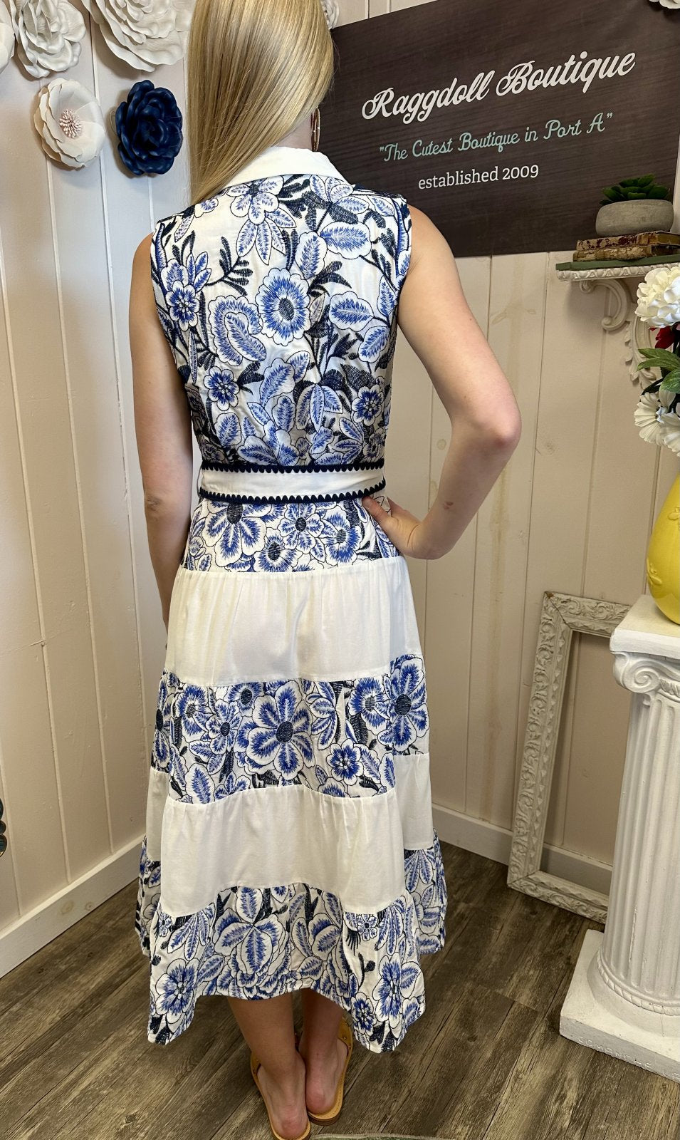 Back view of Adelyn Dress with blue embroidery, perfect for coastal boutique clothing and tropical vacation dresses.