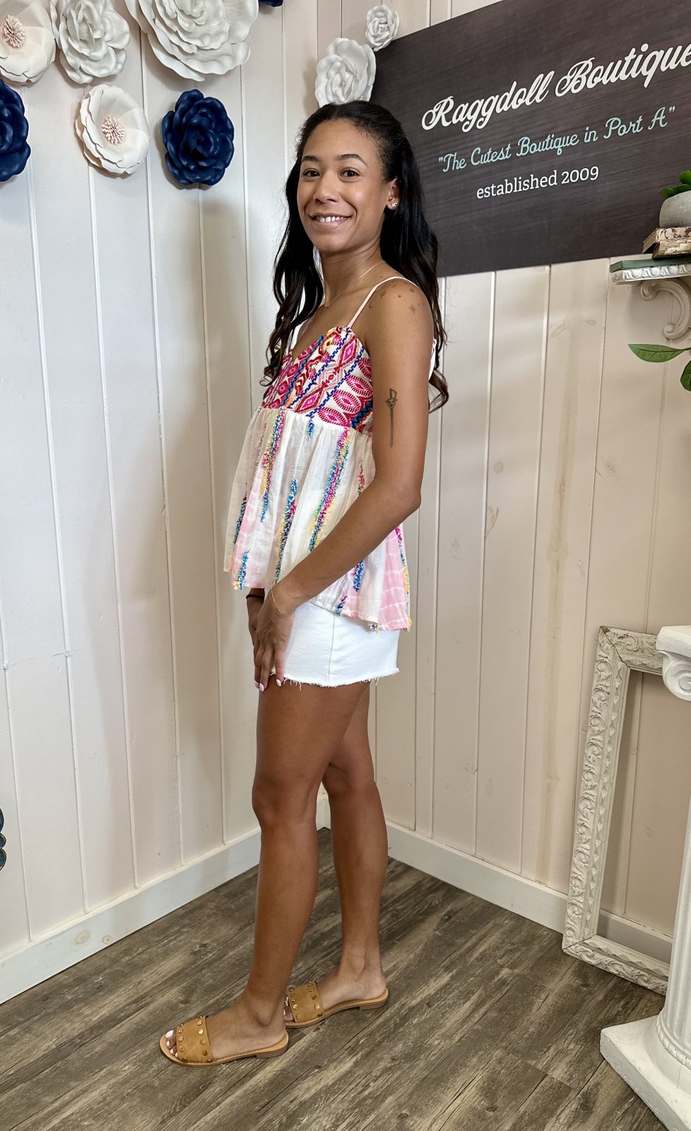 Vibrant Arielle Top with colorful tie-dye print, showcased at Raggdell Boutique, perfect for coastal and beach outfits.