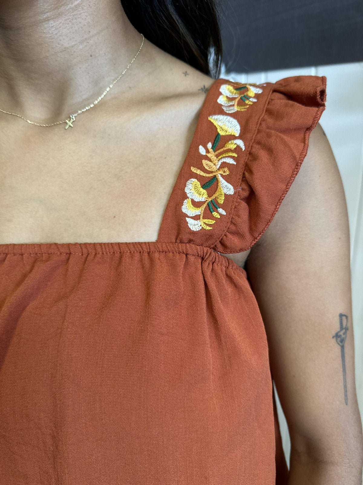 Rust embroidered ruffle sleeve tank top showcasing boho charm, perfect for coastal boutique clothing and curvy fashion.