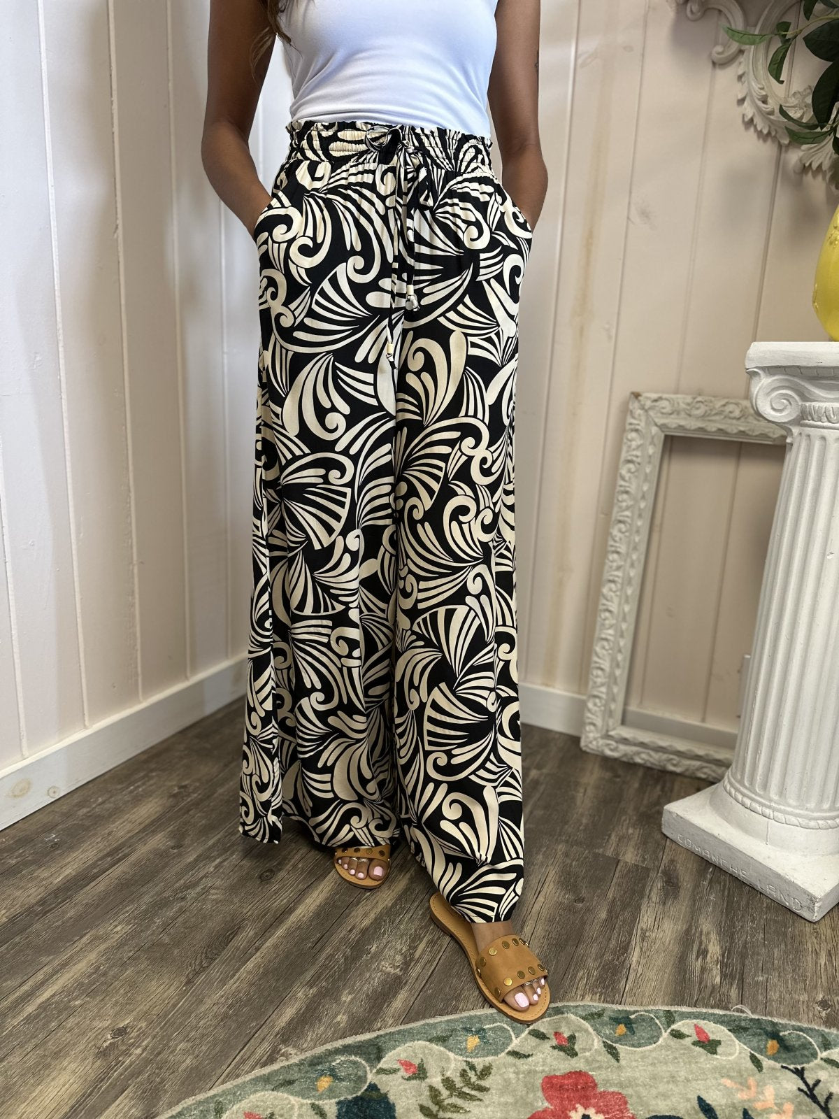 Stella Pants in black floral print, perfect for coastal boutique clothing and curvy plus size fashion. Ideal for tropical vacations.