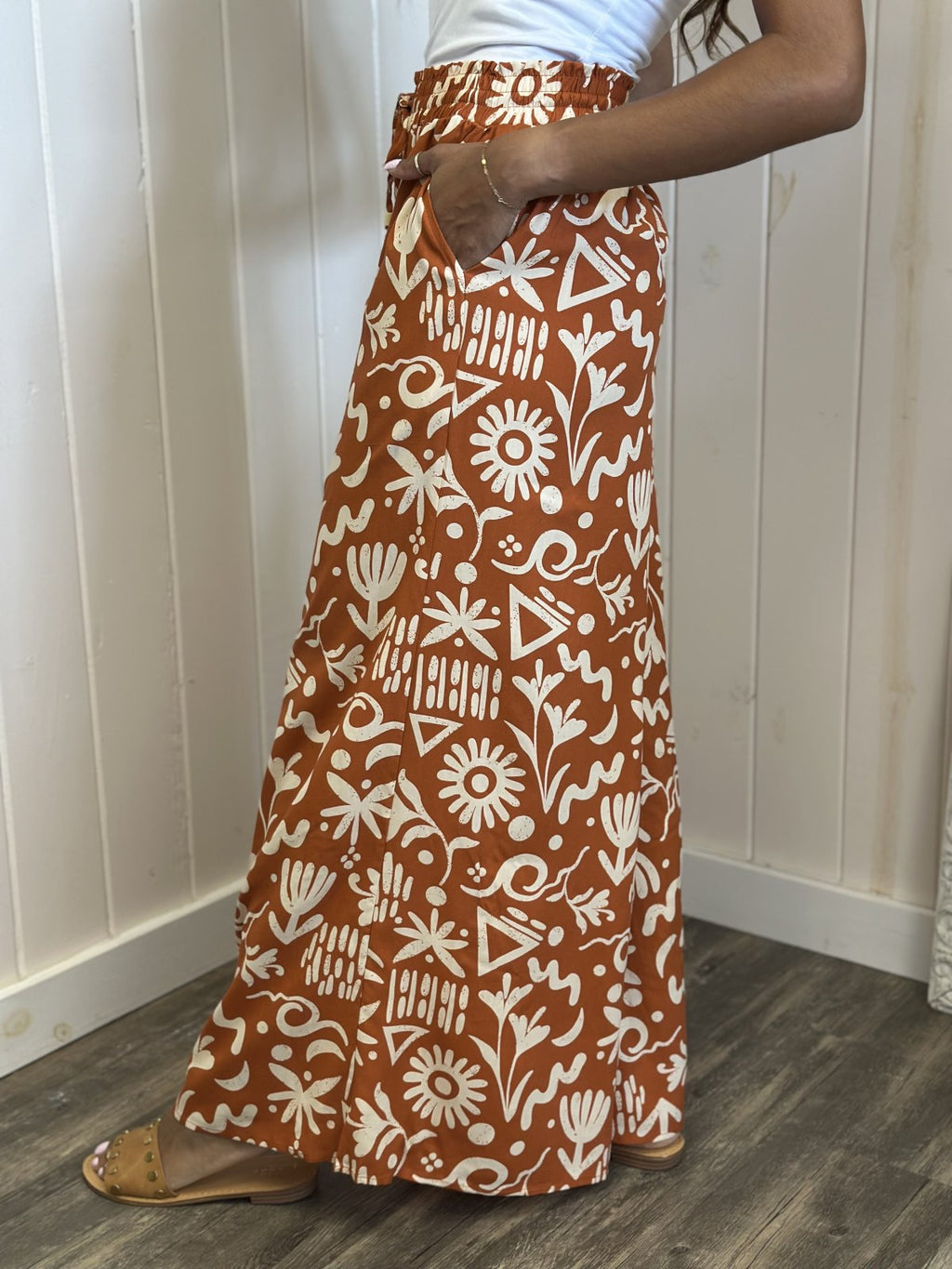 Vibrant Sunset Orange printed wide leg Mila Pants, ideal for coastal boutique clothing and tropical vacation styles.