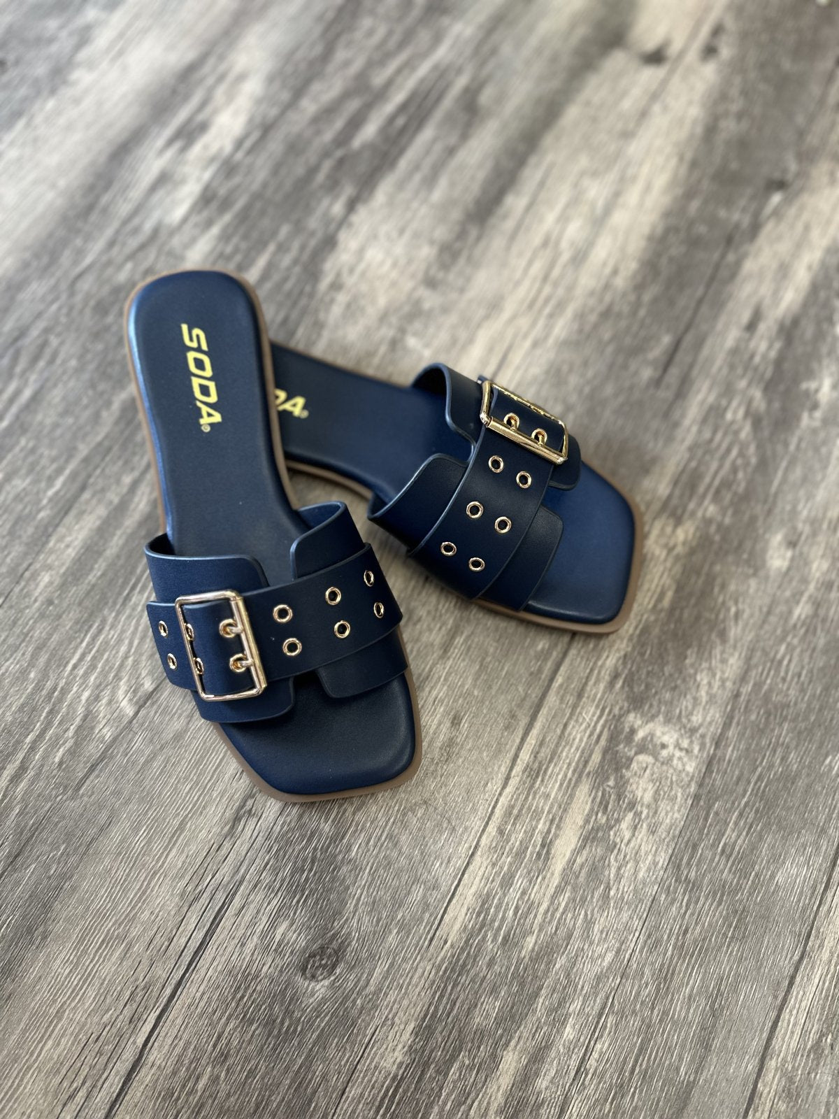 Kendra Navy Slide sandals with buckle design, perfect for coastal boutique clothing and stylish summer outfits.