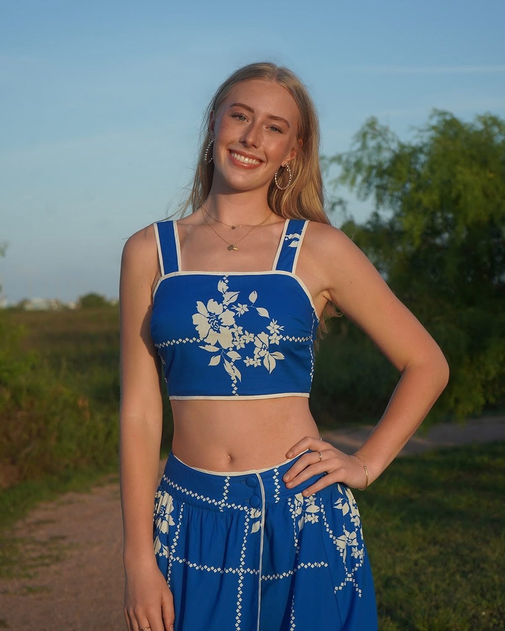 Vibrant cobalt blue crop top with floral print, perfect for coastal boutique clothing and tropical vacation dresses.
