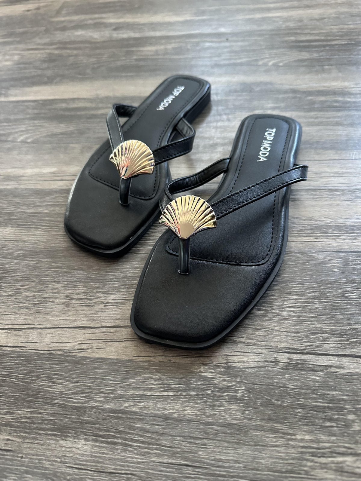 Myra Sandal showcasing trendy coastal style at Raggdoll Boutique in Port Aransas, perfect for summer outfits.