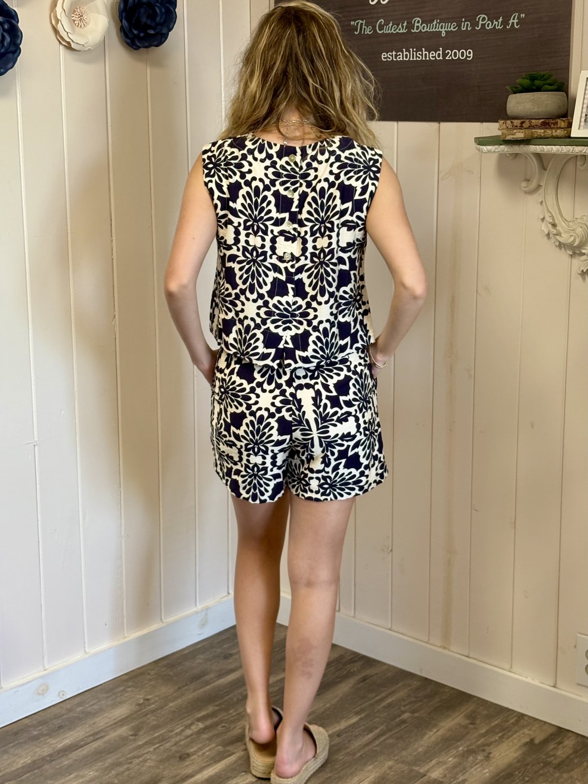 Back view of Becca Top showcasing navy and ivory floral print, perfect for coastal boutique clothing and tropical vacations.