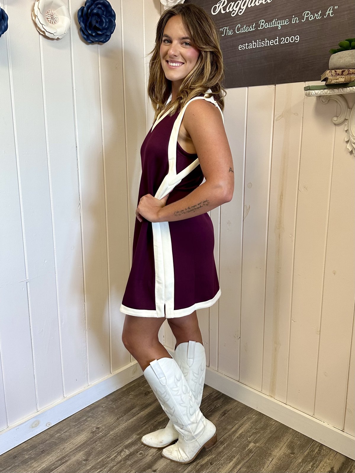 Burgundy sleeveless varsity mini dress showcased at a Port Aransas boutique, perfect for coastal outings and stylish events.