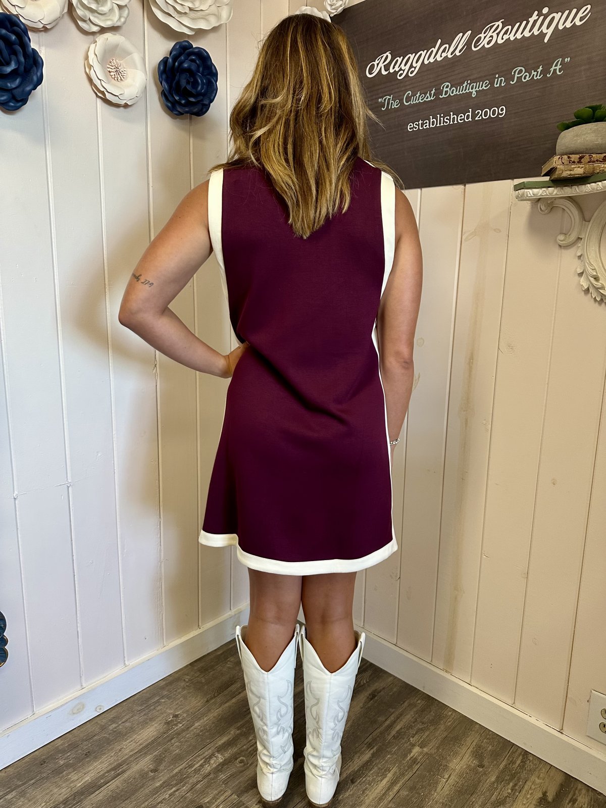Burgundy sleeveless varsity pullover dress, perfect for game day or casual weekends, seen at a coastal beach boutique.
