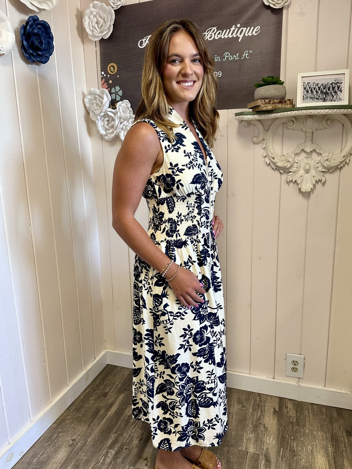 LeAnna Dress worn by a model in Raggdoll Boutique showcasing floral design and navy blue print in Port Aransas.