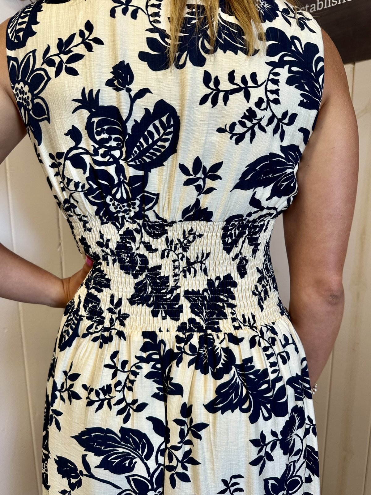 Back view of LeAnna Dress with navy floral print, perfect for summer outfits at Raggdoll Boutique.