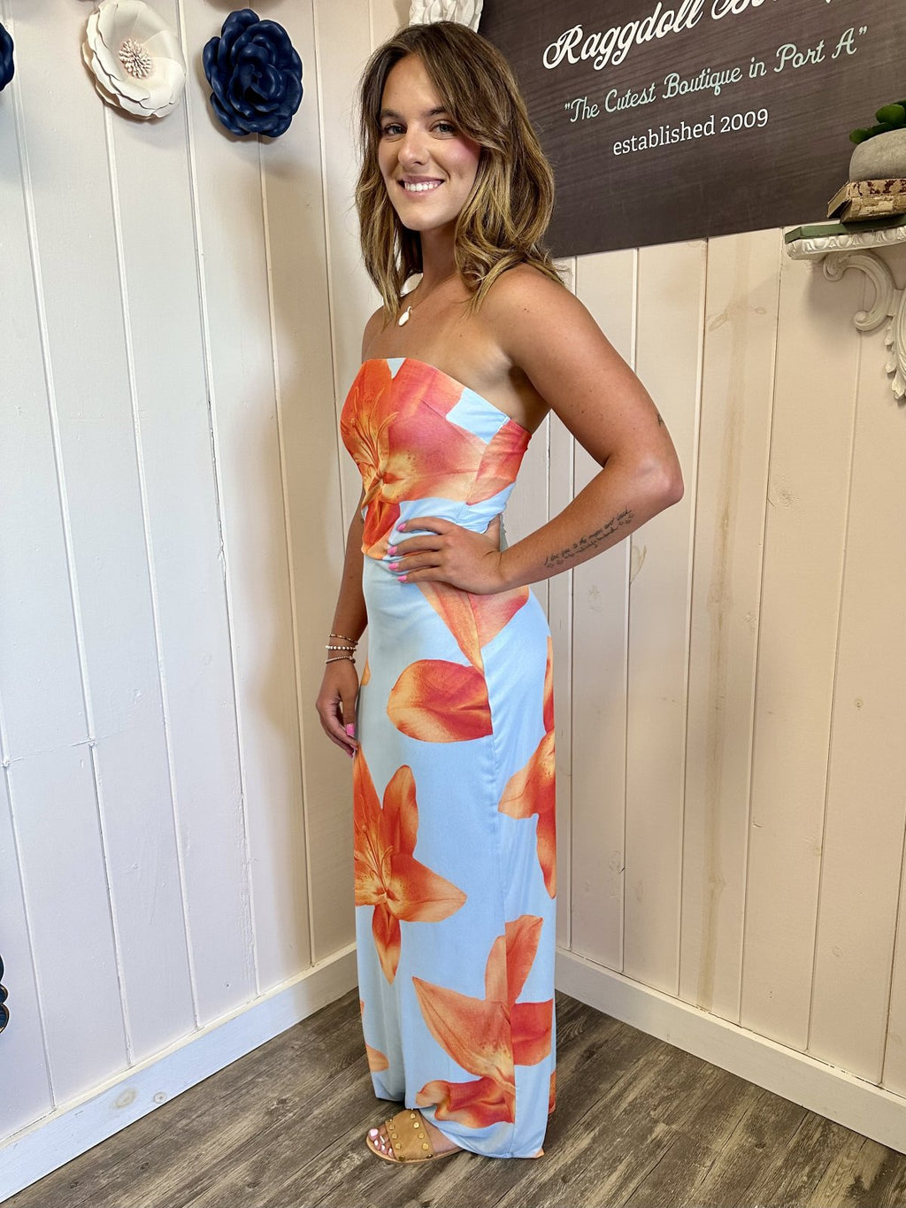 Light blue tropical strapless dress with orange floral print, perfect for beach days and summer vacations from Port A boutique.