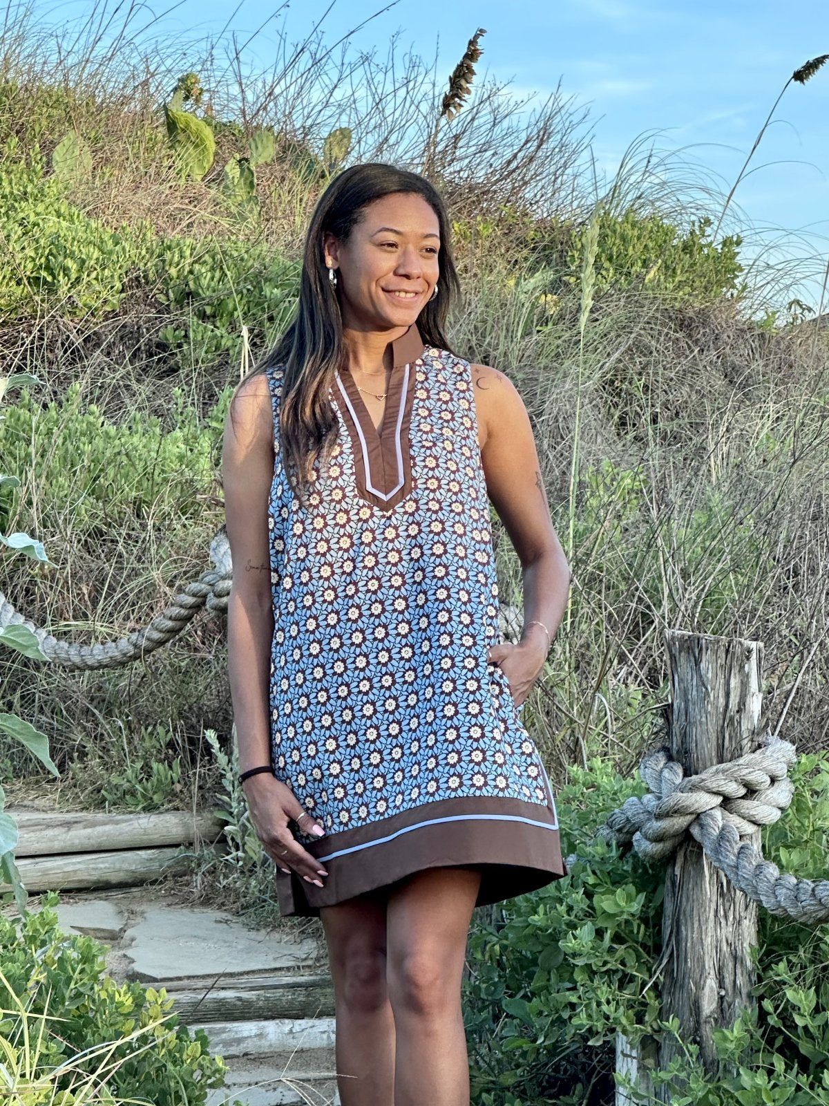 Charlotte Dress from Raggdoll Boutique, a sleeveless mini dress with chambray blue and brown floral print.