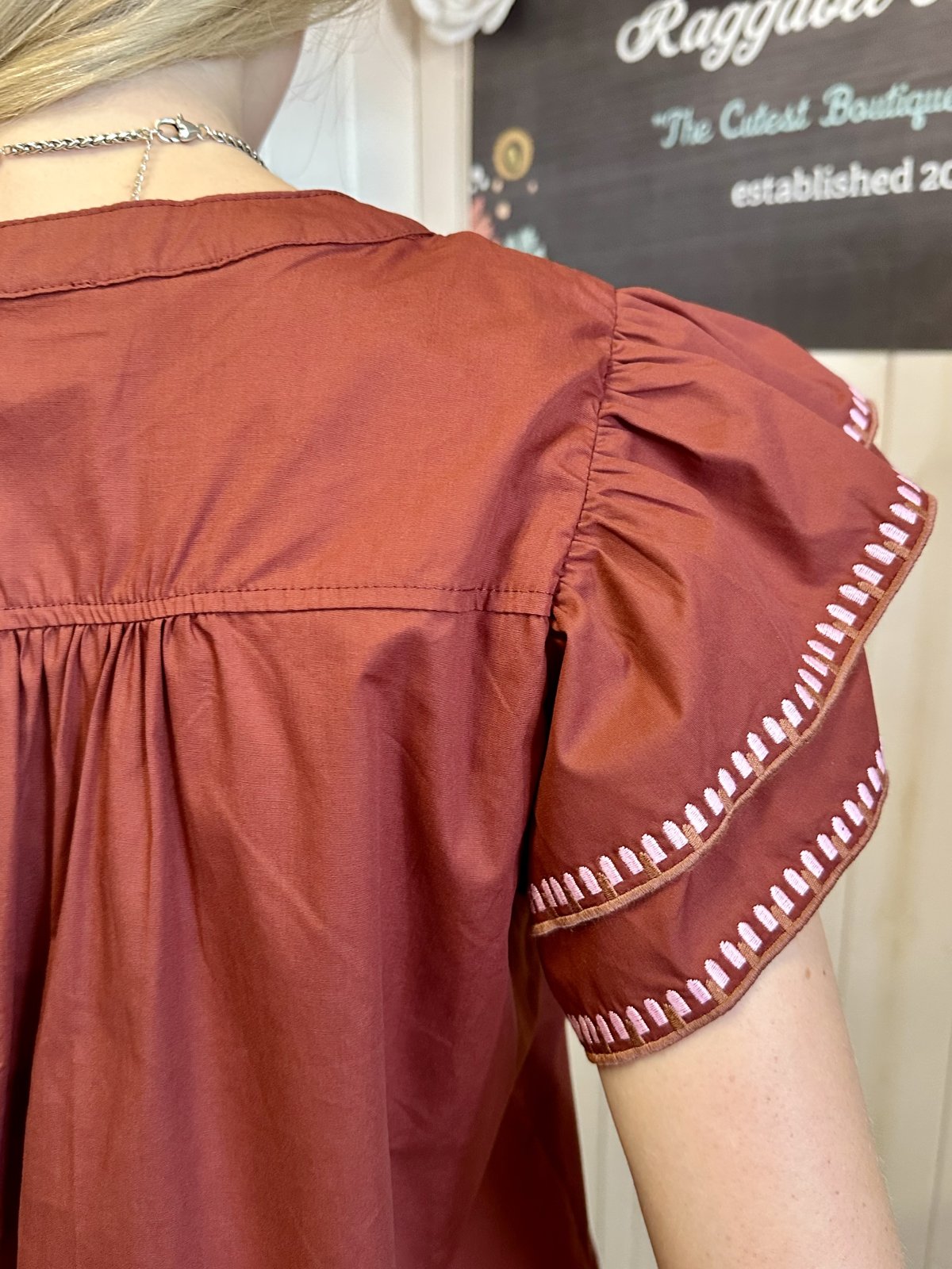 Back view of Willow Top with ruffle flutter sleeves and embroidered trim, perfect for summer outfits Texas.