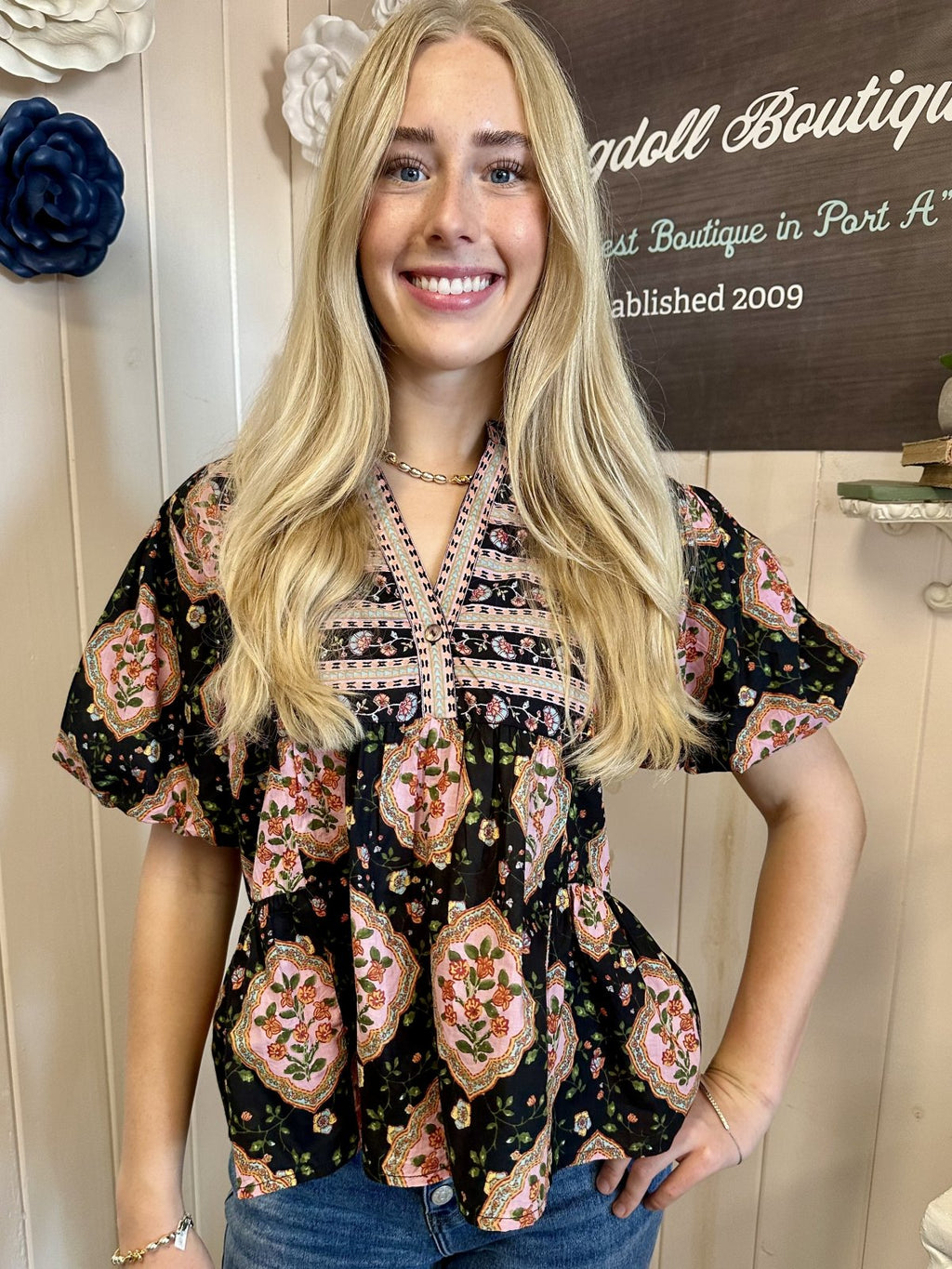 Sarah Top from Raggdoll Boutique featuring black and pink floral print with puff sleeves, perfect for trendy coastal style.
