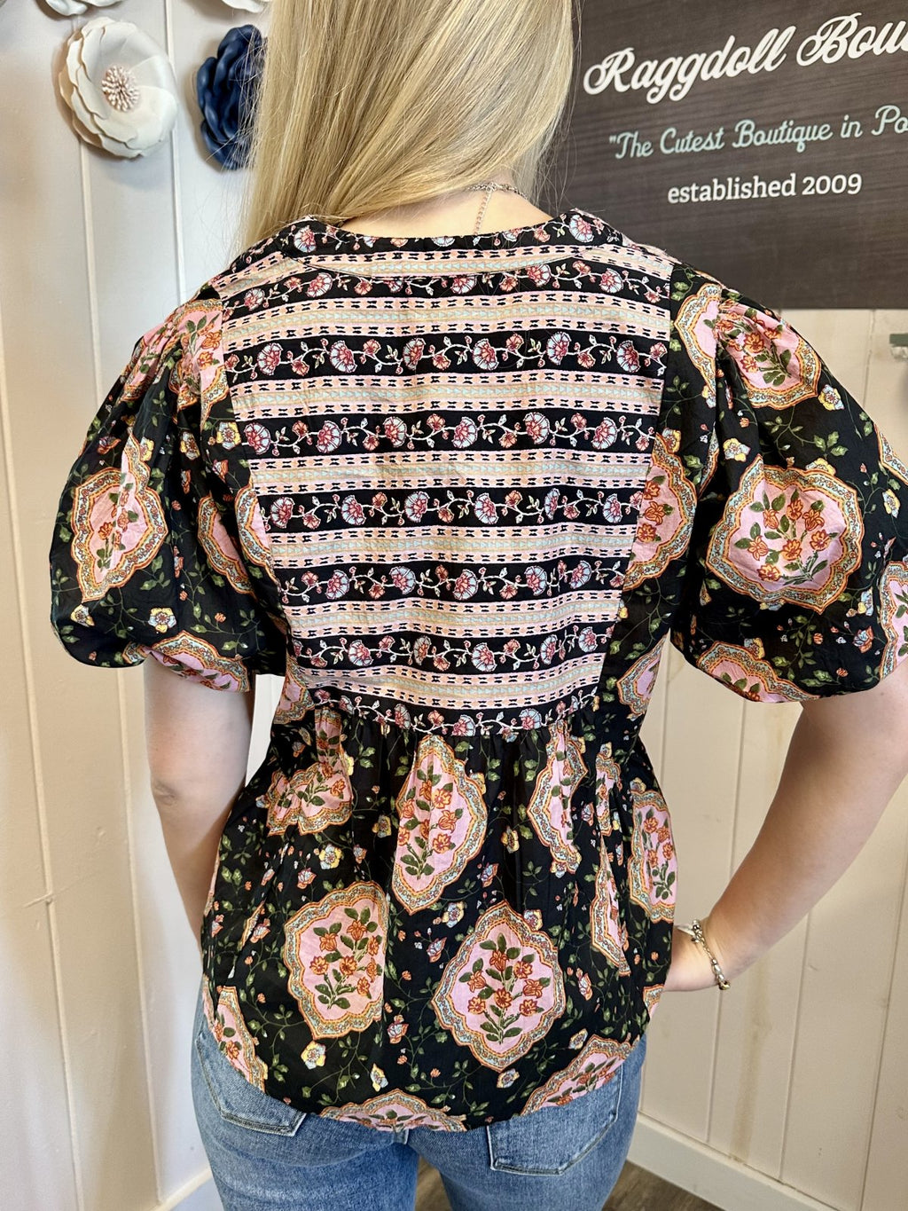 Back view of Sarah Top featuring floral design and puff sleeves, perfect for trendy coastal style from Raggdoll Boutique.