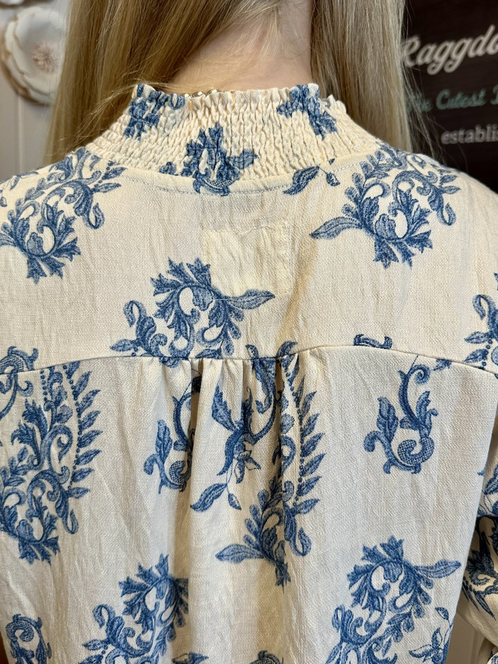 Smocked collar detail of a floral print top from Raggdoll Boutique, ideal for coastal fashion in Port Aransas.