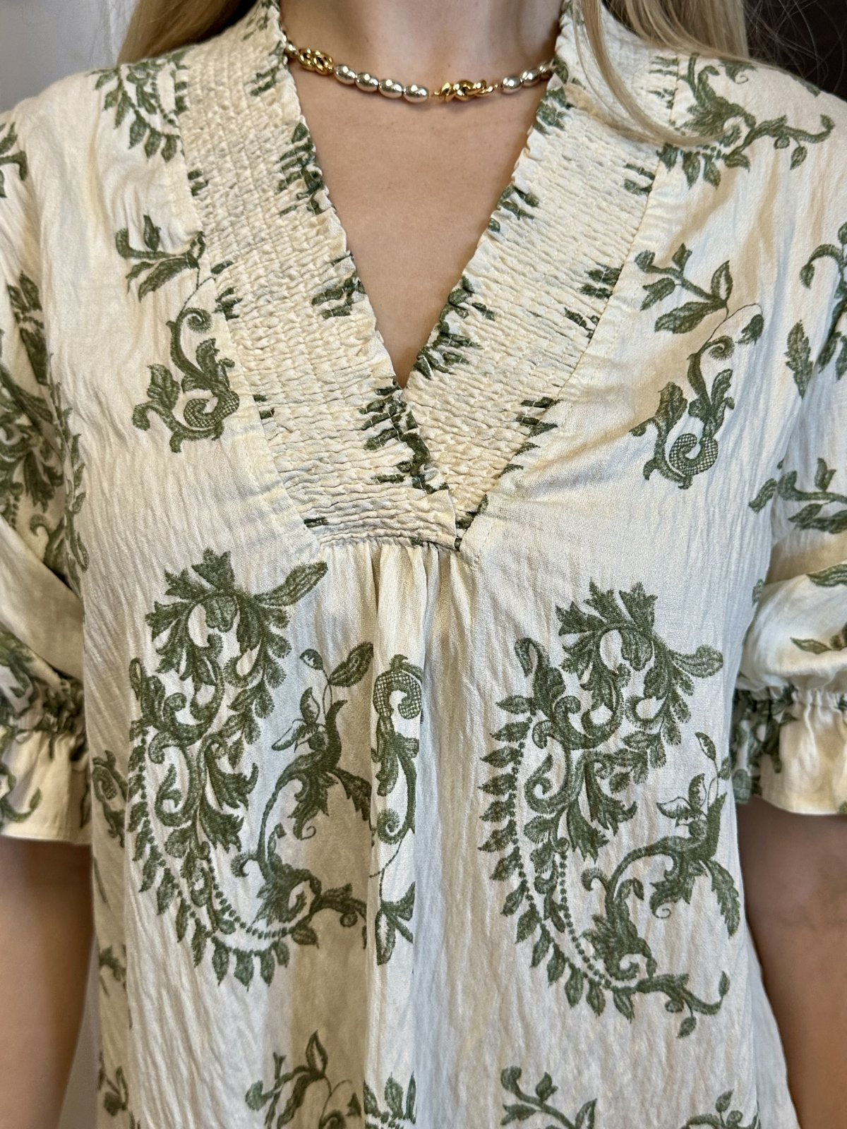 Elegant boutique dress with green floral embroidery from Raggdoll Boutique, perfect for trendy coastal style in Port Aransas.