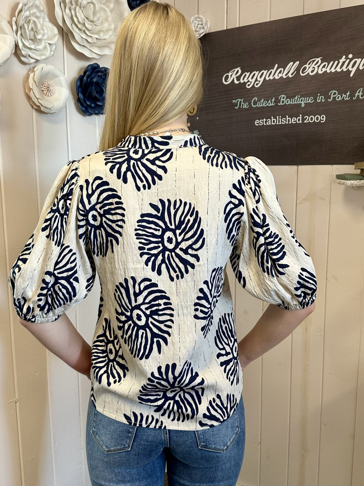 Back view of the Mary Top featuring navy abstract print and puff sleeves, available at Raggdoll Boutique.