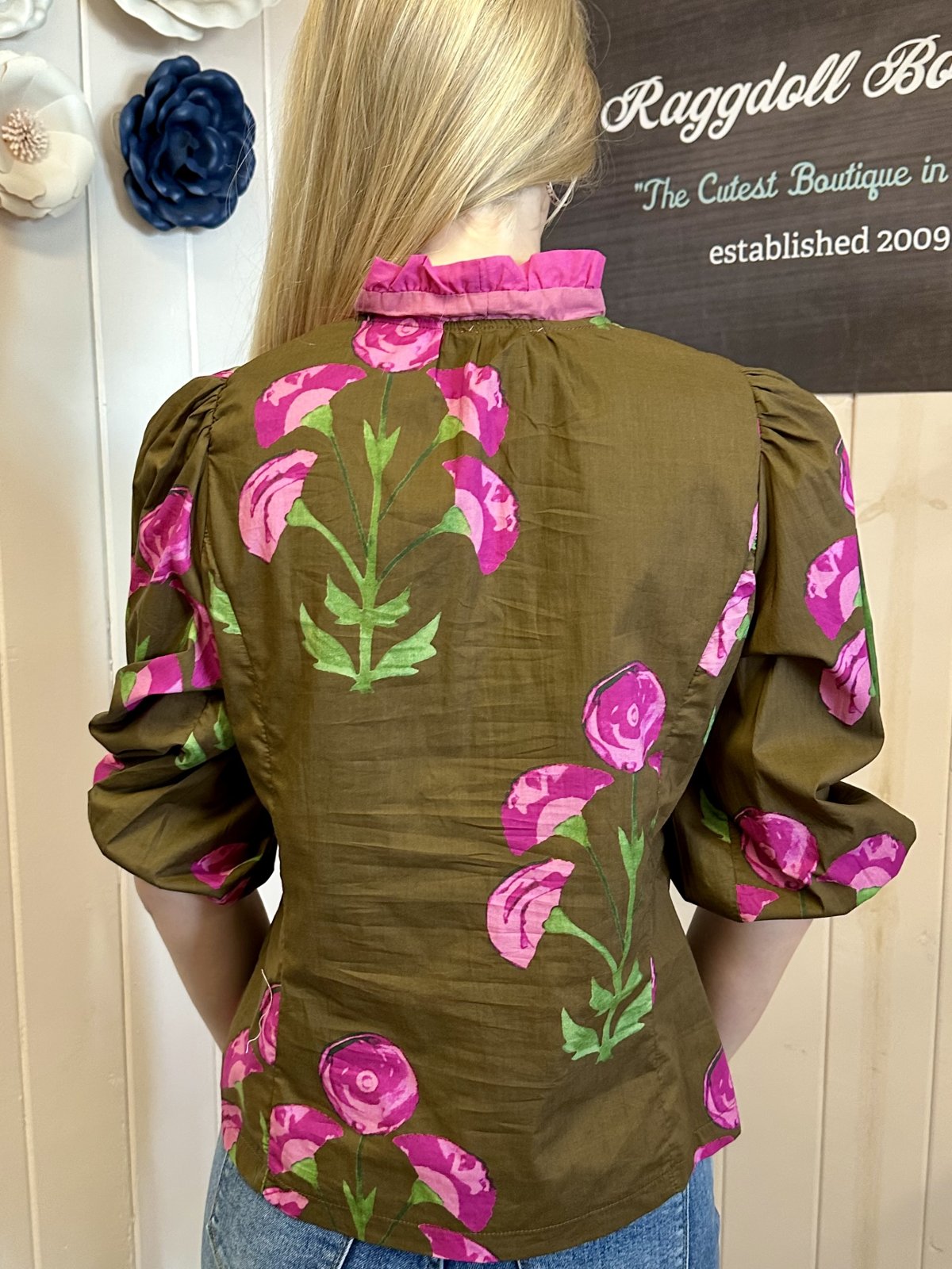 Back view of Maple Top with floral print, 3/4 puff sleeves, from Raggdoll Boutique, showcasing trendy coastal style.