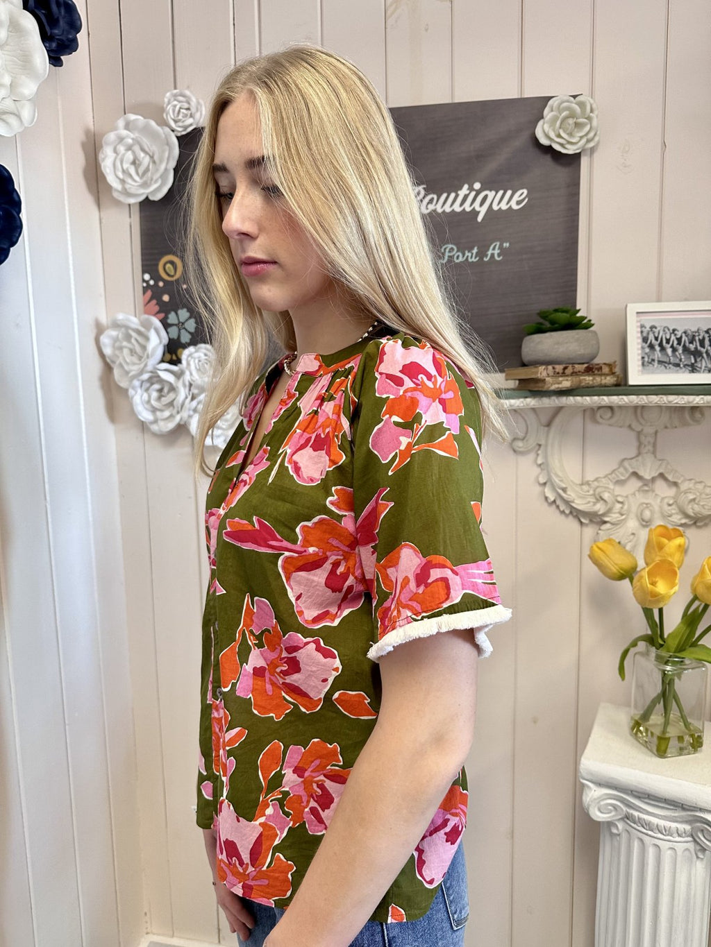 Stevie Top from Raggdoll Boutique features olive floral design and fringe sleeves, ideal for trendy coastal style.