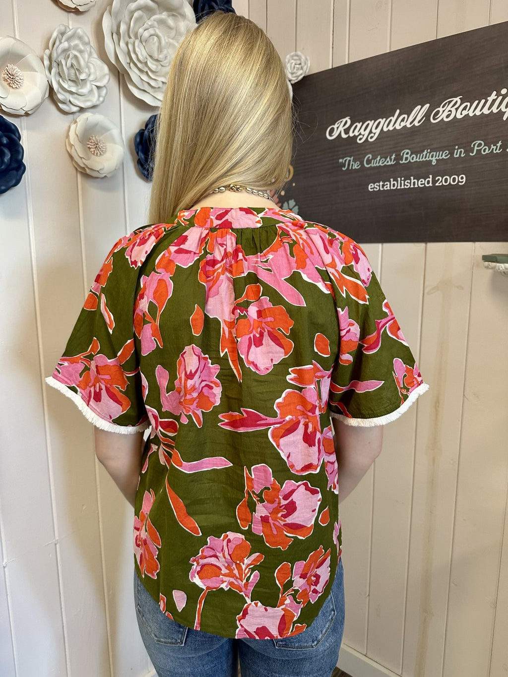 Olive floral top with fringe sleeves showing a vibrant pink design at Raggdoll Boutique - Stevie Top.