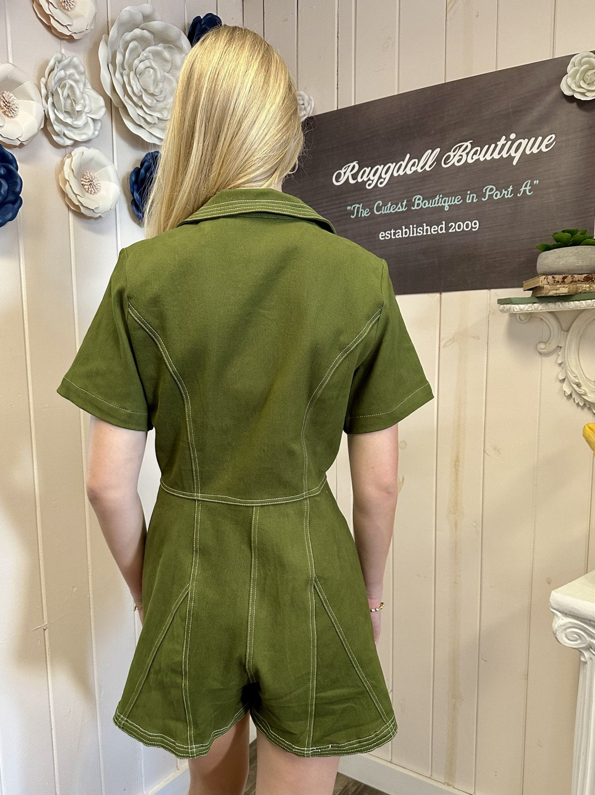 Back view of Taylor Romper from Raggdoll Boutique showcasing olive fabric and contrast stitching details.