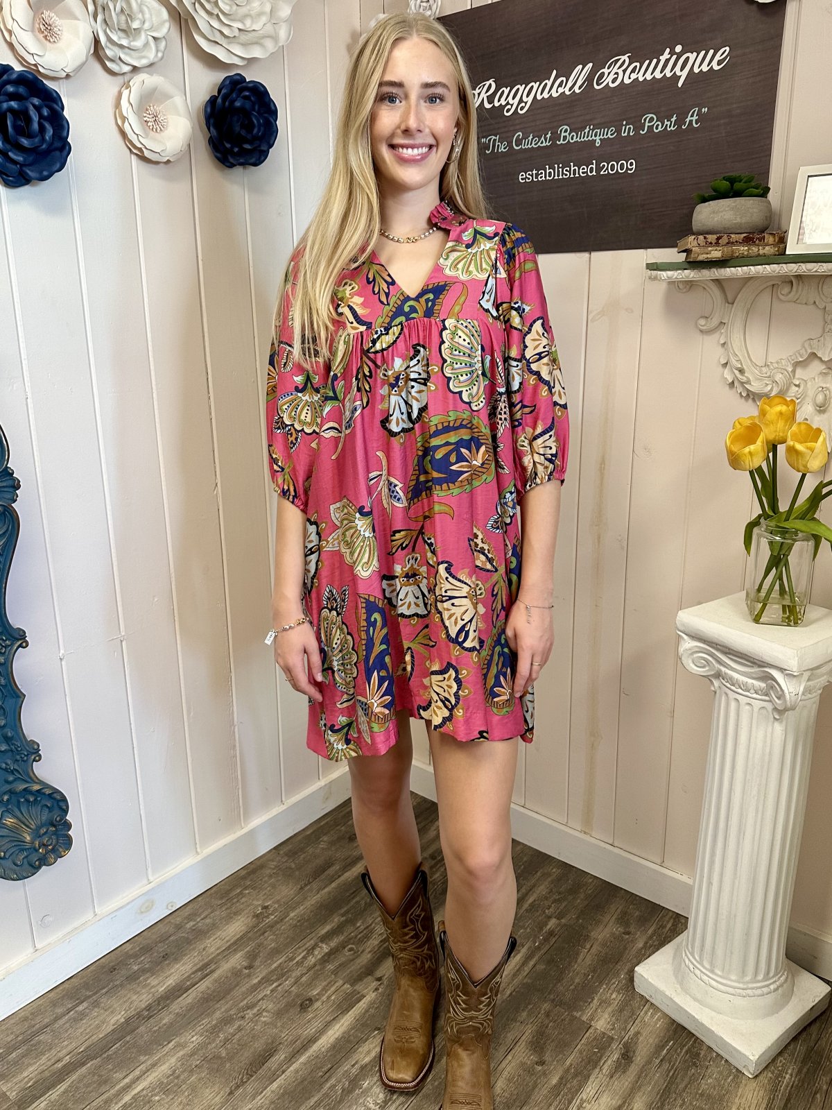 Pamela Dress in pink abstract print with puff sleeves, styled with cowboy boots at Raggdoll Boutique.