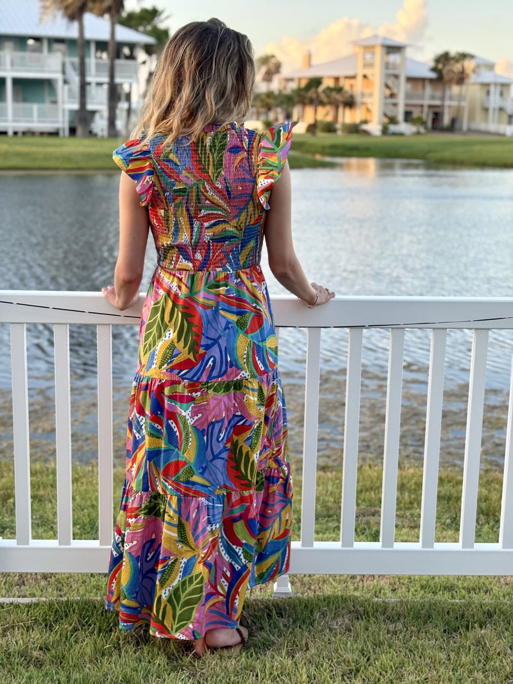 Giselle Dress in vibrant floral print, perfect for coastal boutique clothing and tropical vacations. Flattering fit for curvy fashion.