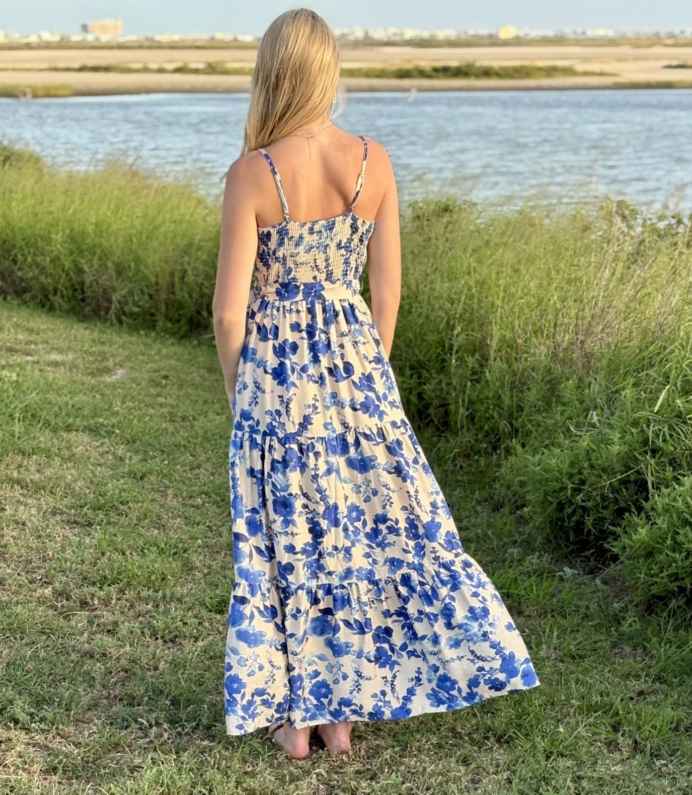 Model wearing blue floral print maxi dress, perfect for coastal boutique clothing and tropical vacation dresses.