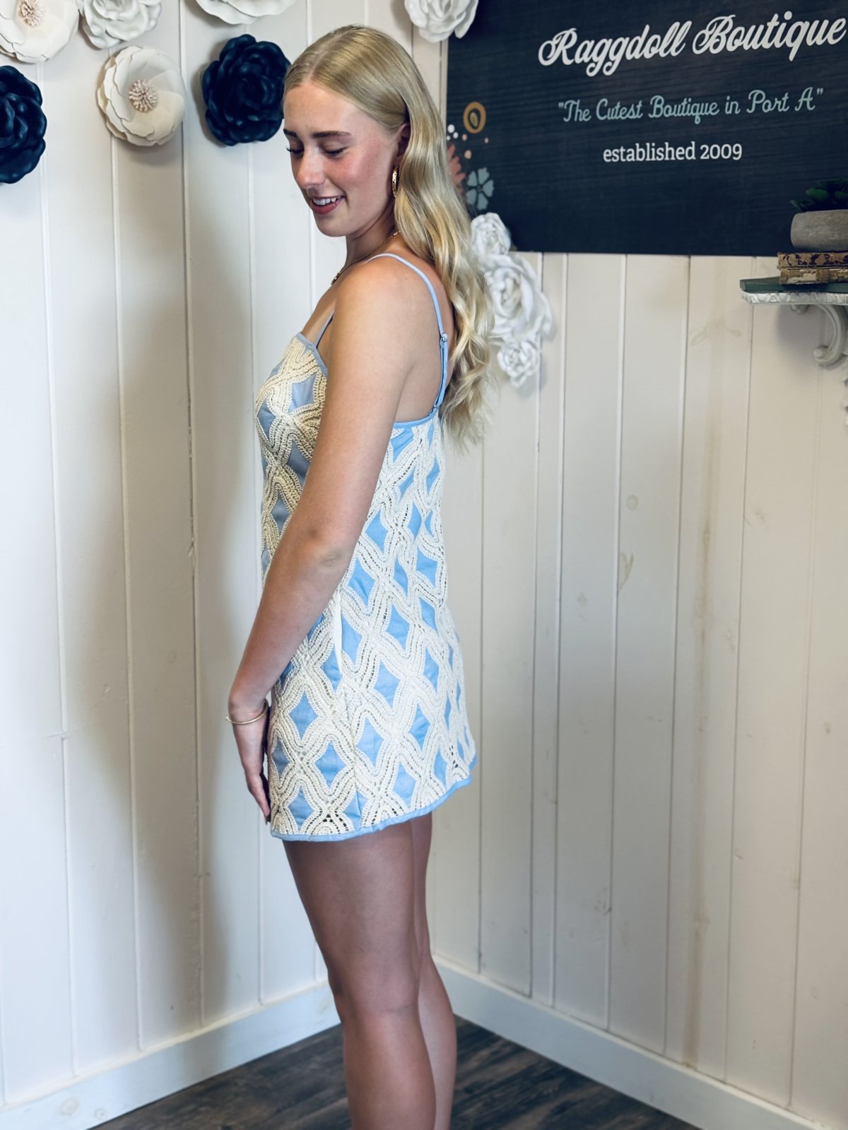 Model in Tabitha Dress at Raggdoll Boutique, showcasing stylish mini dress perfect for coastal boutique clothing and beach outings.
