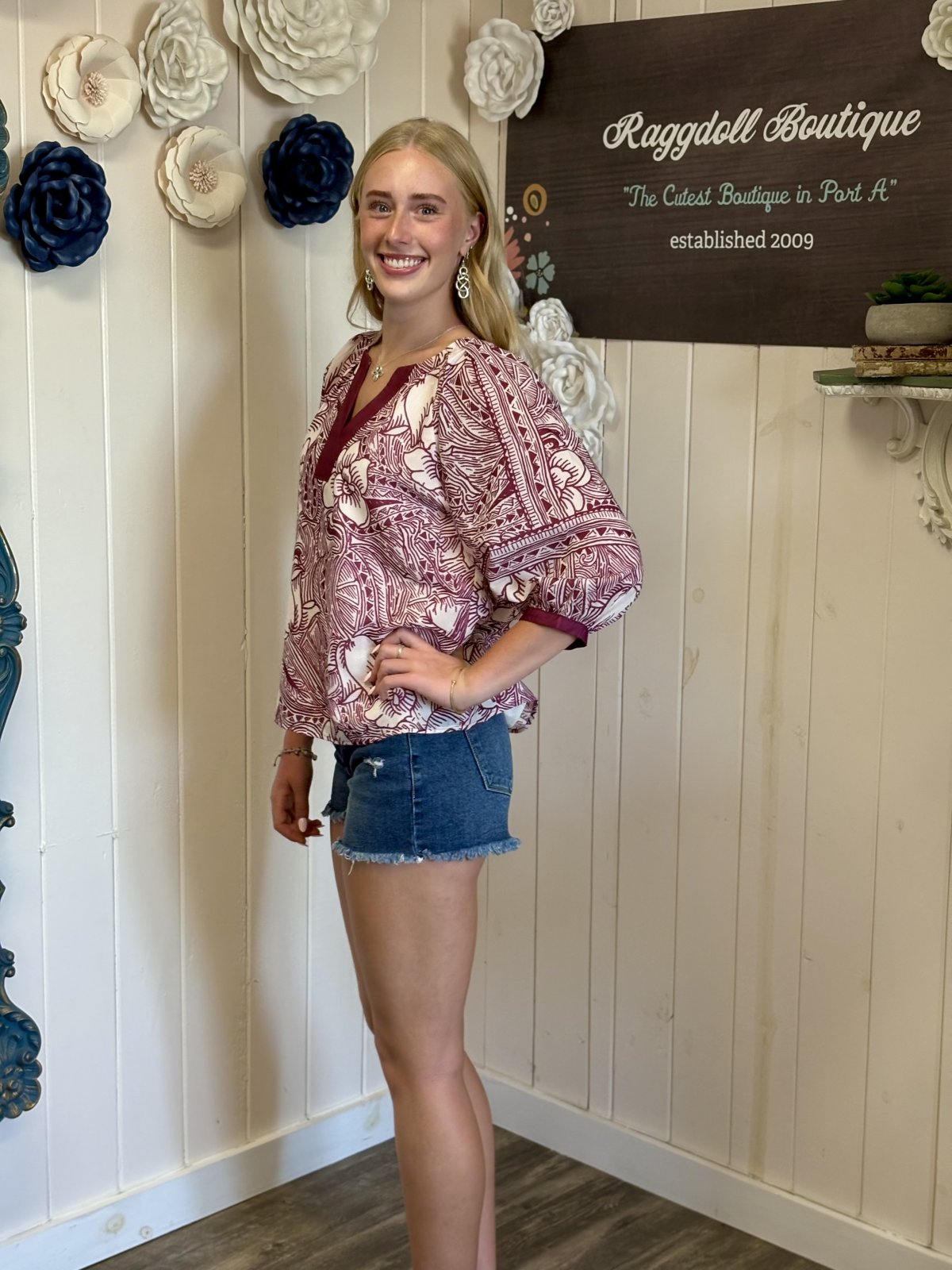 Model showcasing a stylish boho blouse with shorts, perfect for summer at Raggdoll Boutique in Port A.