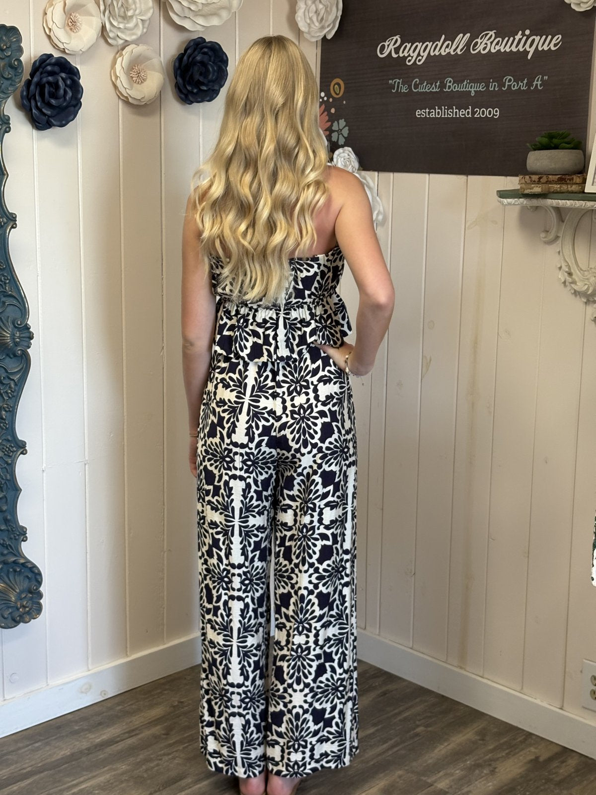 Navy and ivory strapless jumpsuit from Raggdell Boutique, showcasing beach-ready style and a flowy fit perfect for tropical vacations.