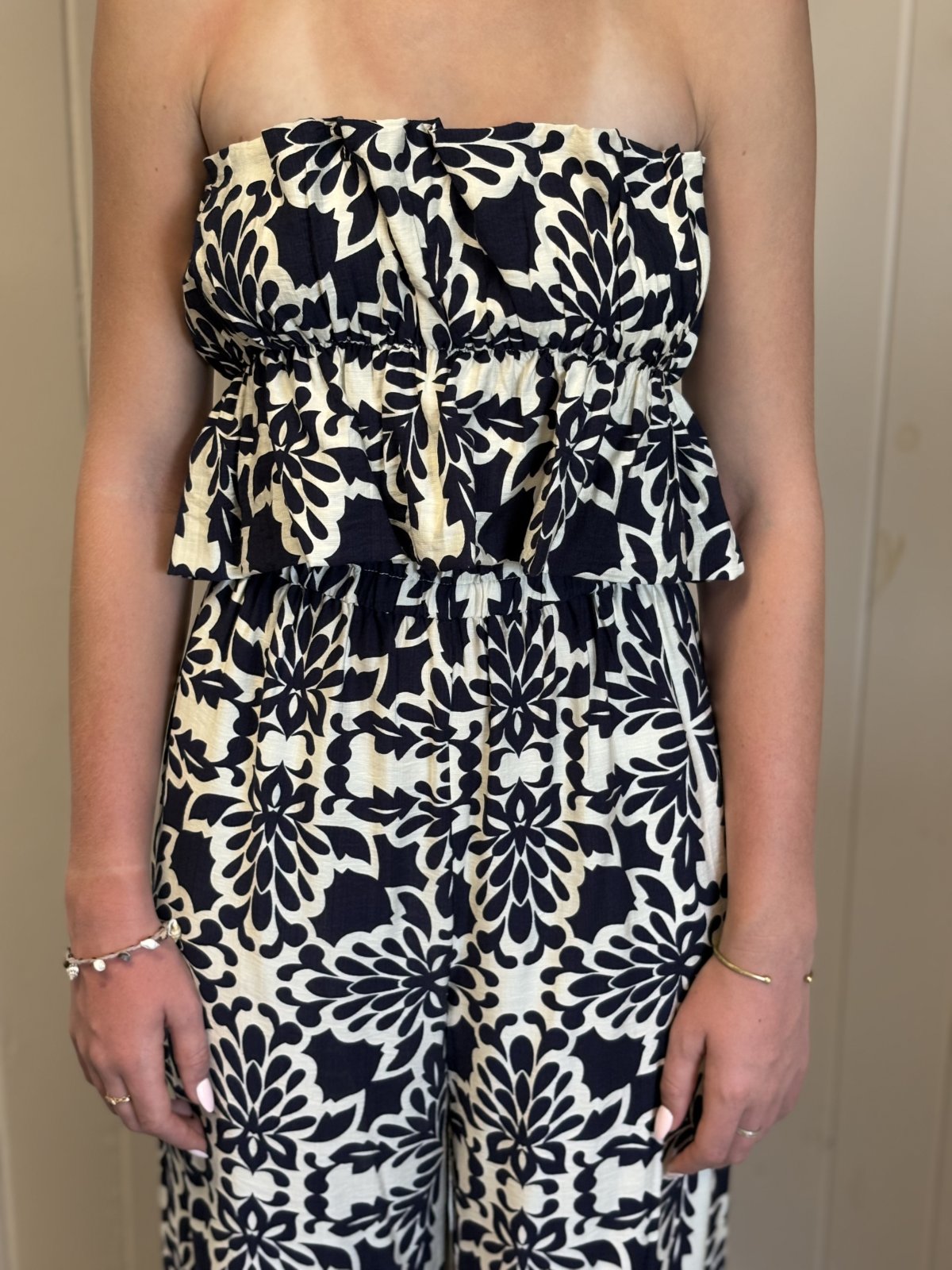 Stylish strapless navy and ivory printed jumpsuit, perfect for warm-weather outings from a coastal boutique clothing.