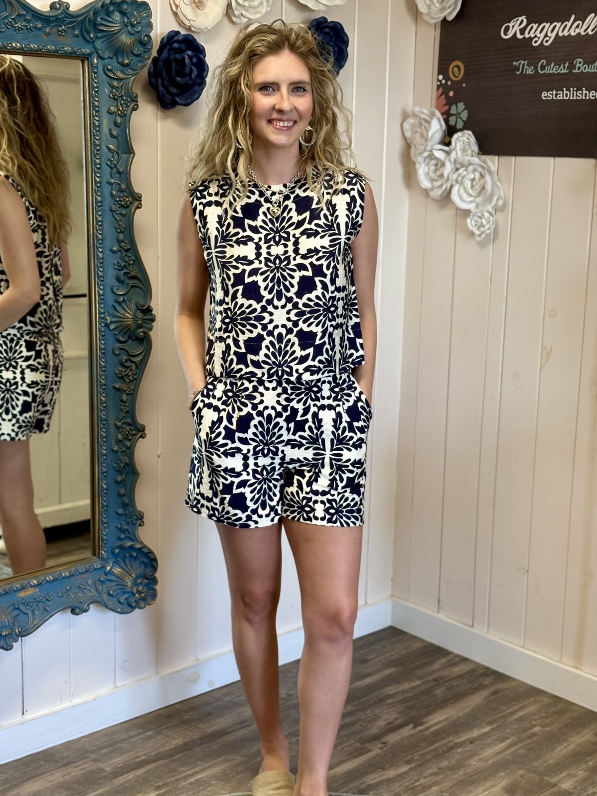 Chic navy and ivory sleeveless top featuring pockets from a coastal boutique, perfect for beach days and tropical vacations.