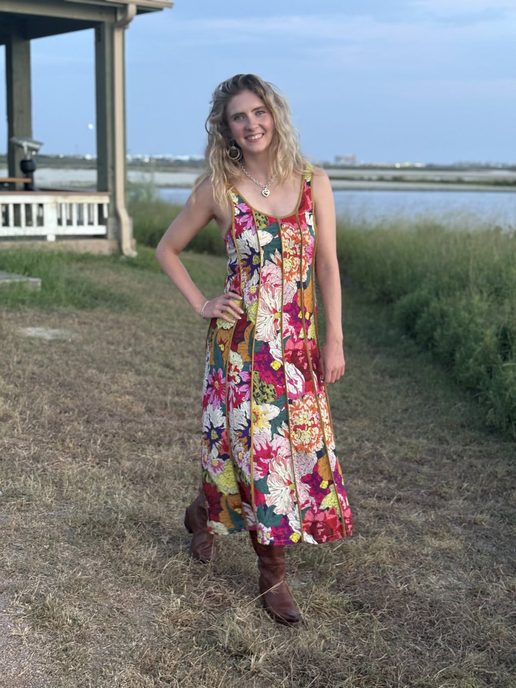 Model wearing Callista floral midi dress in a coastal setting, perfect for beach days and outdoor events.