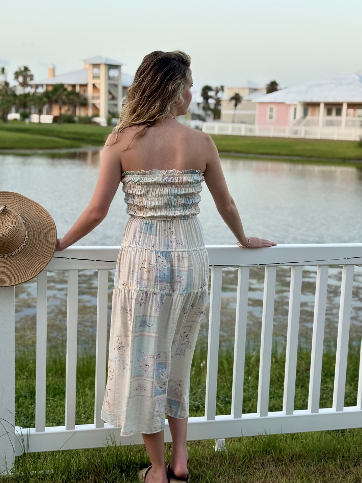 Mollie Dress showcasing a model by the water in a coastal setting, perfect for summer outfits Texas from Raggdoll Boutique.