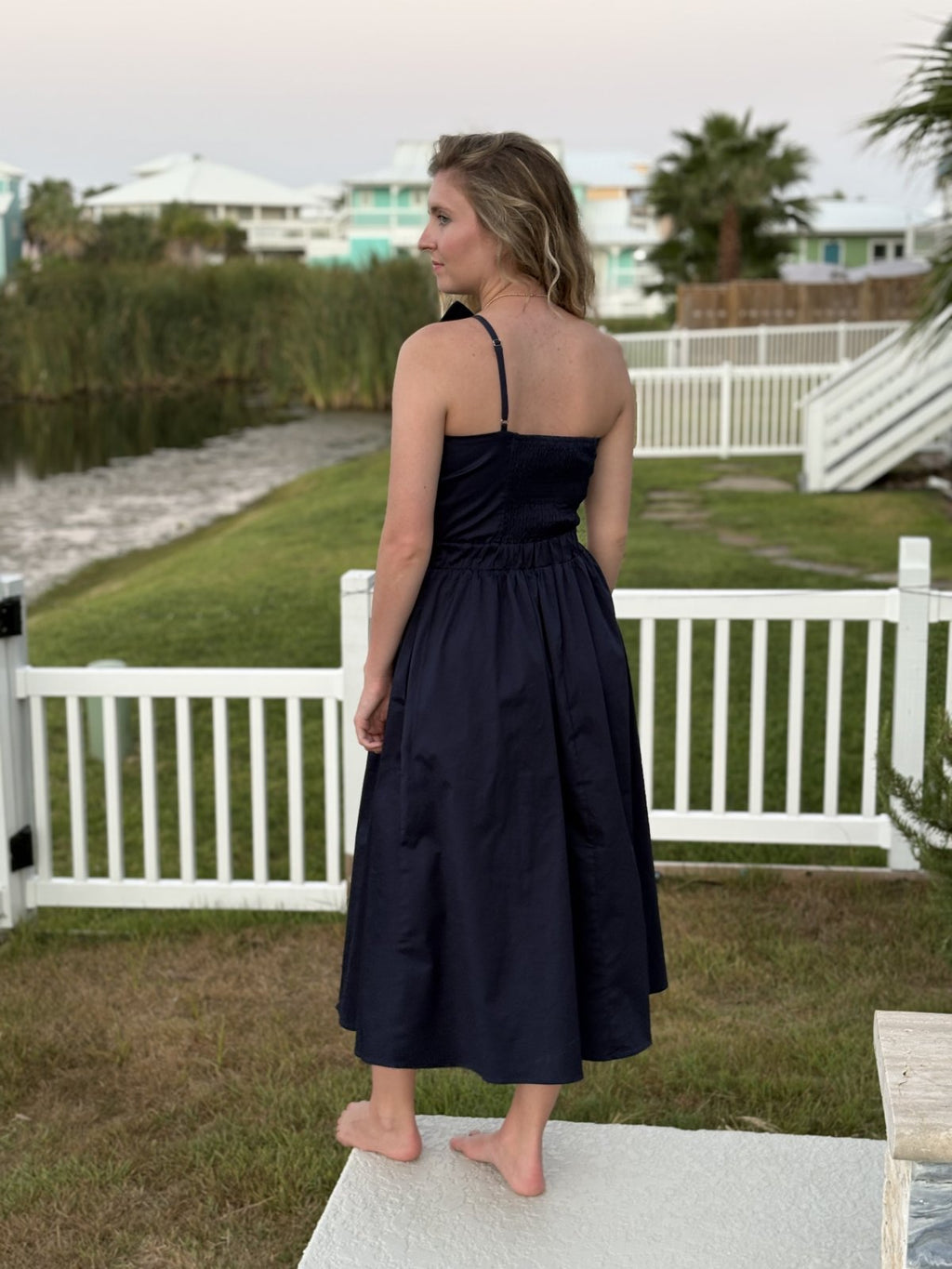 Stylish Navy Knot Twisted Midi Dress from a coastal boutique, perfect for beach outings and tropical vacations.