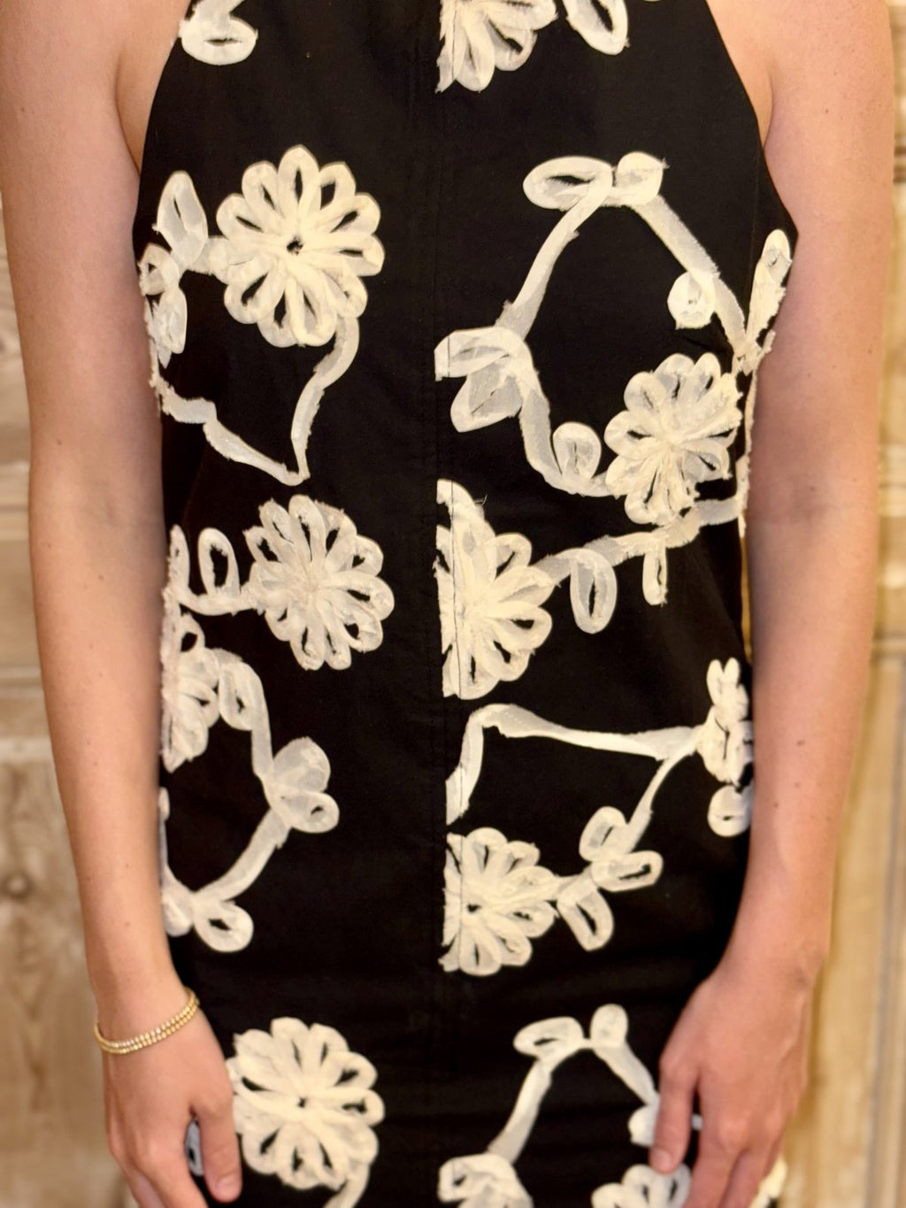 Chic black Ember Dress with cream embroidered flowers, perfect for coastal boutique clothing styles.
