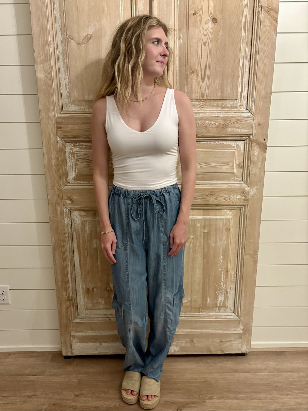 Model wears Eliza Pants from our coastal boutique, showcasing relaxed fit denim perfect for beach days and stylish outings.