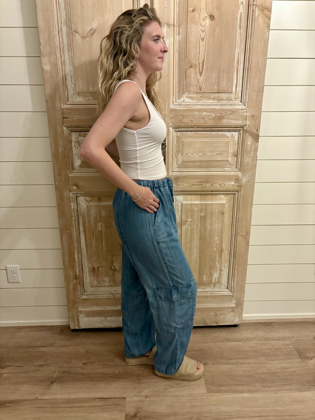 Stylish Eliza Pants in medium wash denim, featuring an elastic waistband, side pockets, perfect for relaxed coastal outings.